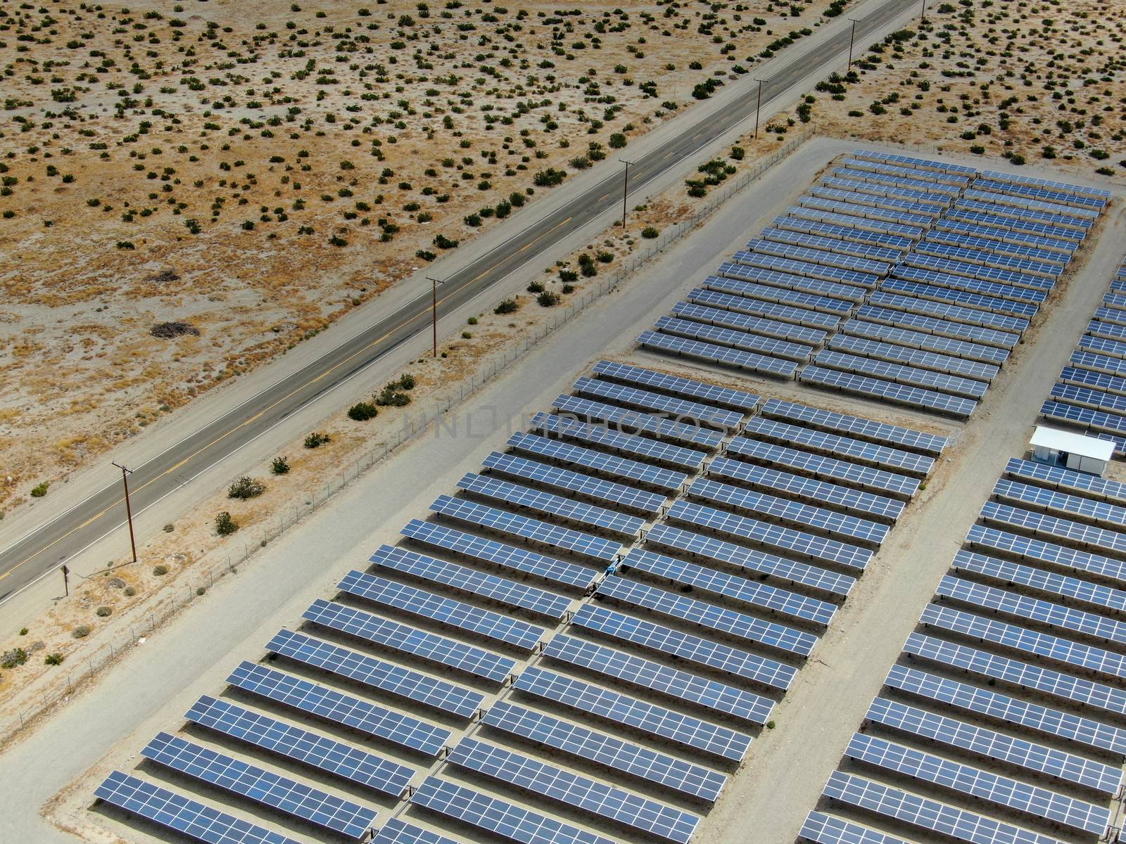 Aerial view of Genuine Energy Farm in the Hot Arid Desert of Palm Springs, California. Solar Panels farm to Harness the Power of Nature to generate free green energy.