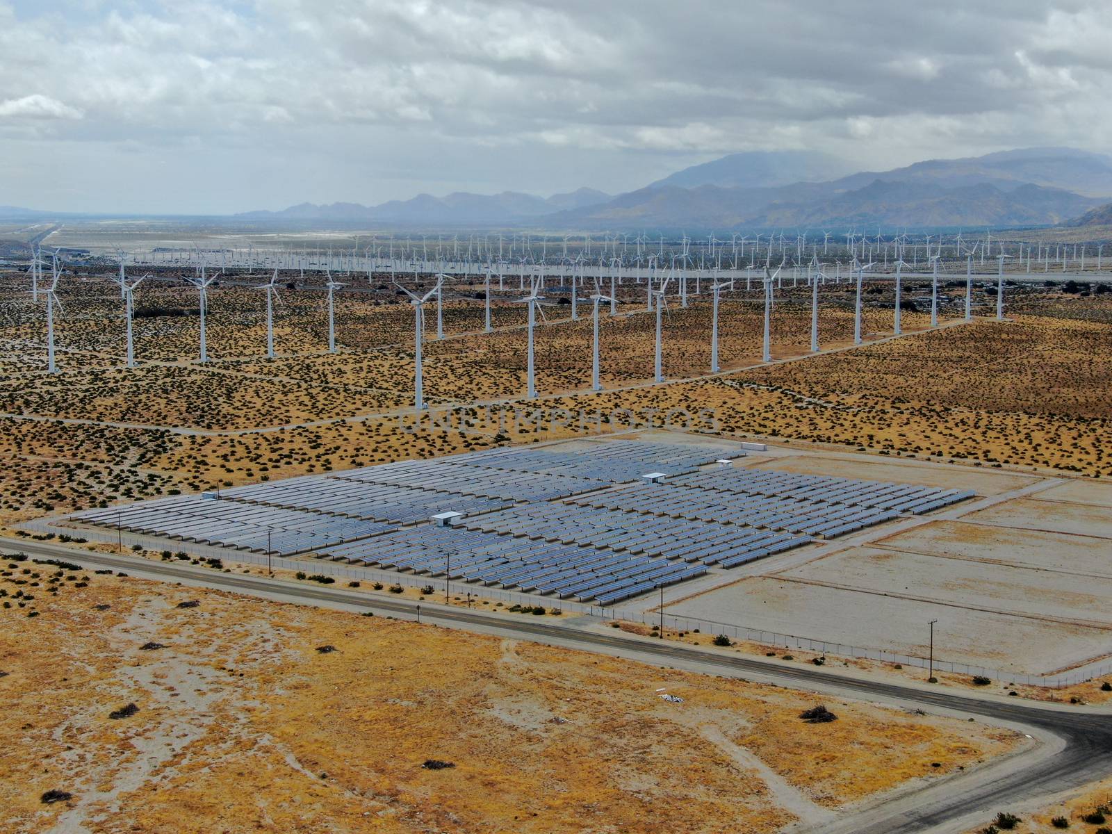 Aerial view of Genuine Energy Farm in the Hot Arid Desert of Palm Springs, California. Solar Panels farm to Harness the Power of Nature to generate free green energy.