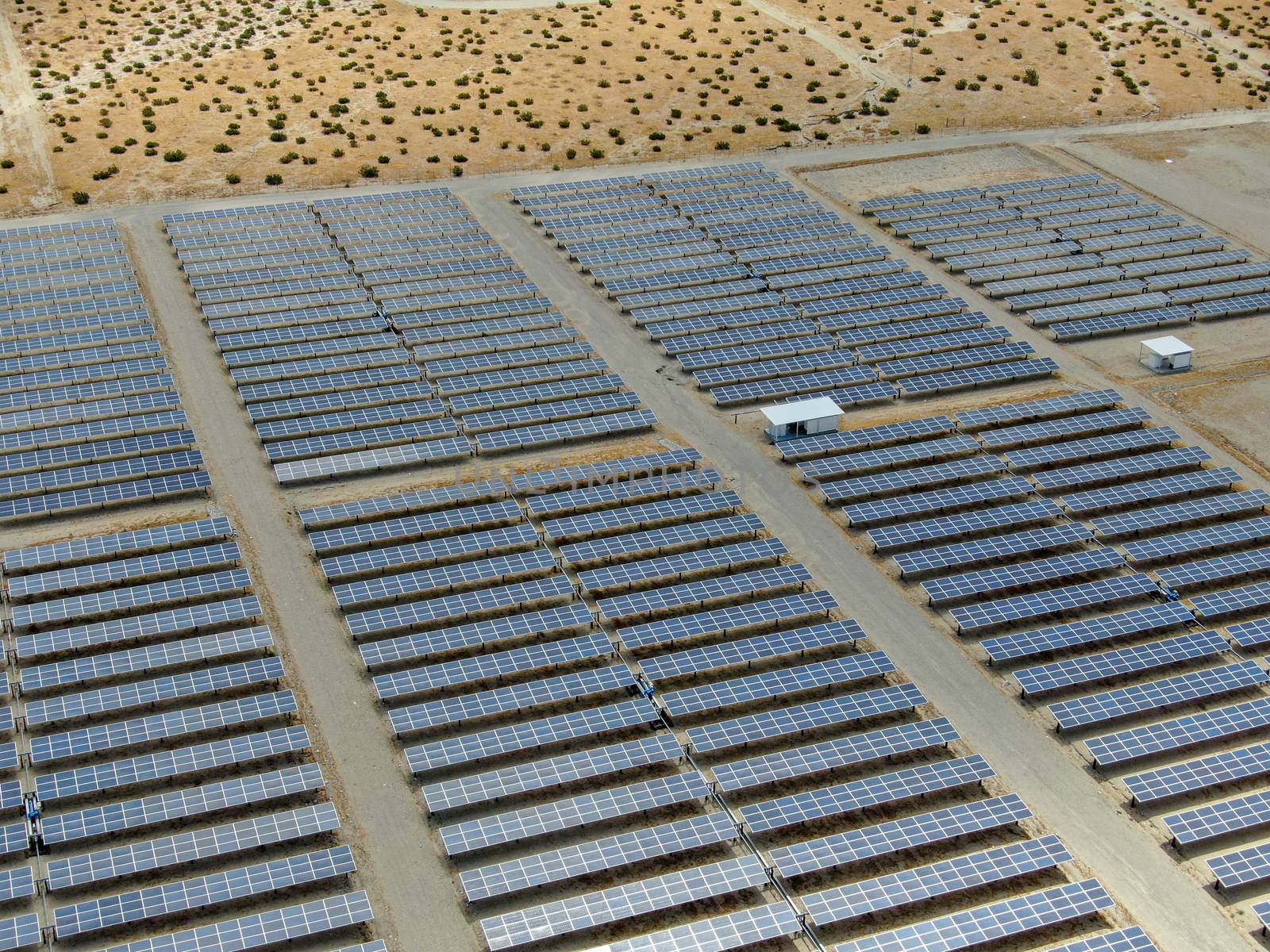 Aerial view of Genuine Energy Farm in the Hot Arid Desert of Palm Springs, California. Solar Panels farm to Harness the Power of Nature to generate free green energy.