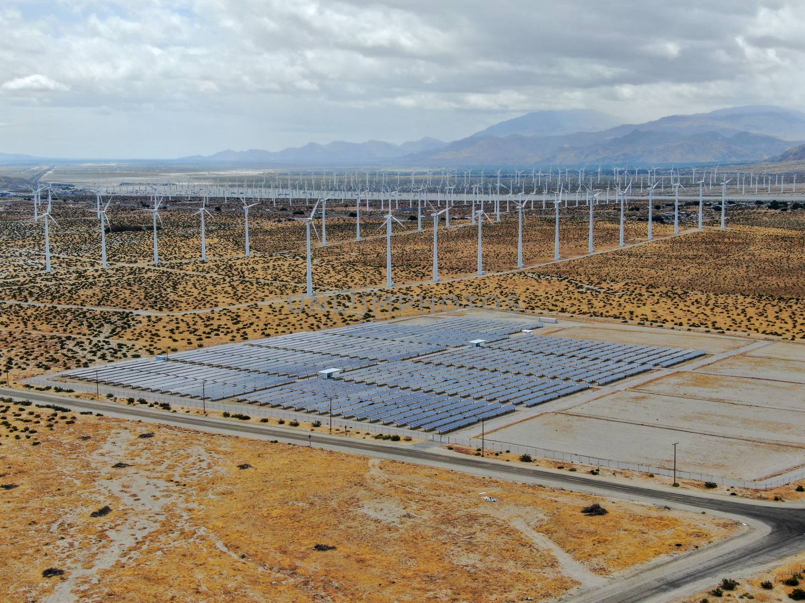 Aerial view of Genuine Energy Farm in the Hot Arid Desert of Palm Springs, California. Solar Panels farm to Harness the Power of Nature to generate free green energy.