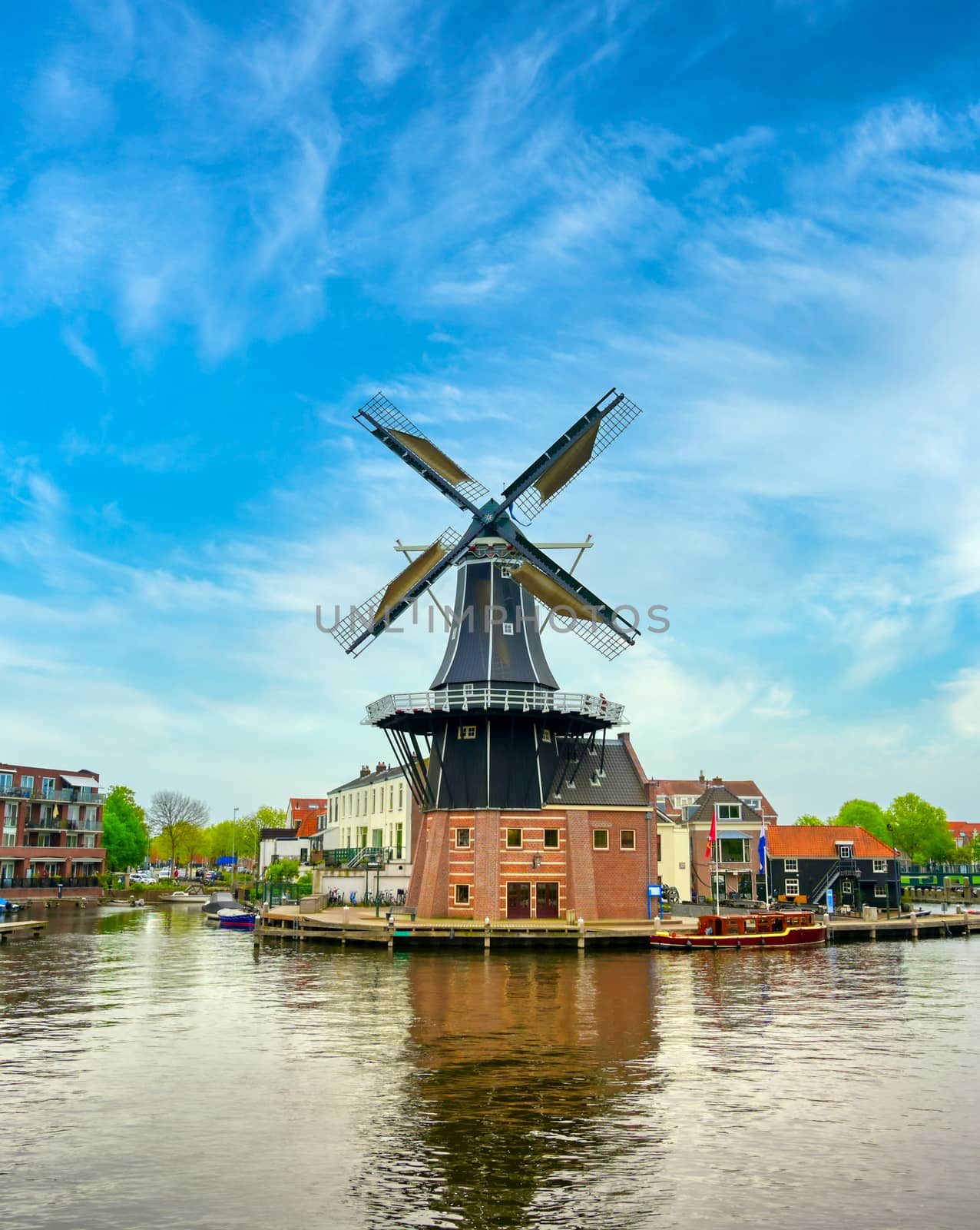 A windmill along the canals in Haarlem, Netherlands on a clear day.