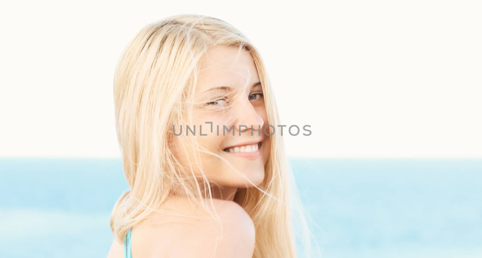 Woman with blond hair enjoying seaside and beach lifestyle in summertime, holiday travel and leisure concept