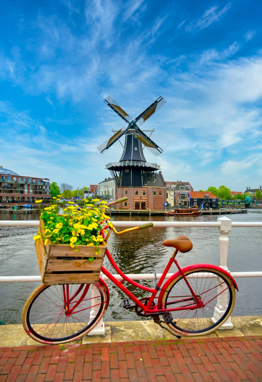 A windmill along the canals in Haarlem, Netherlands on a clear day.