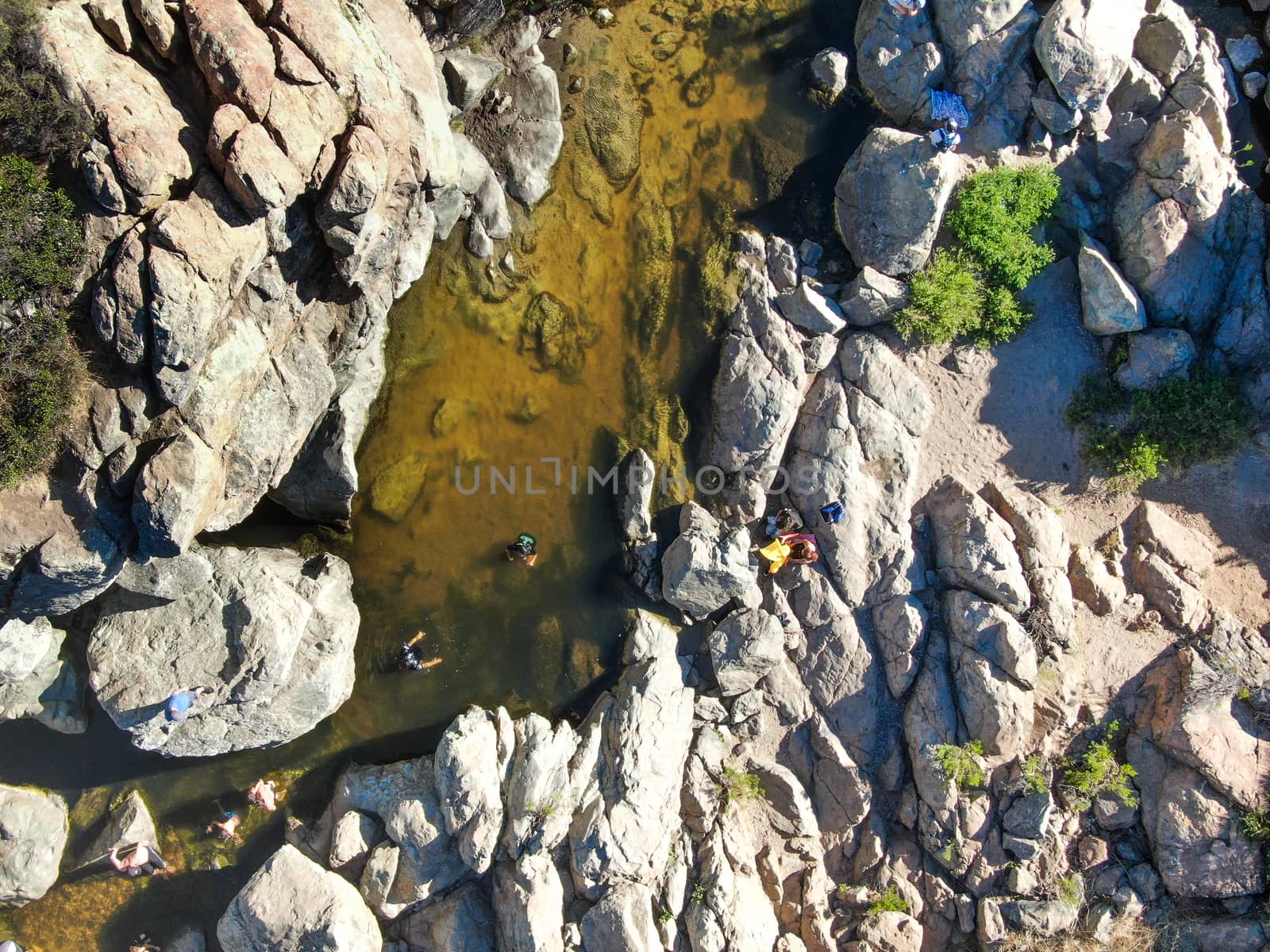 Aerial view of Los Penasquitos Canyon Preserve with the creek waterfall and people enjoying the water. Urban park with trails and river in San Diego, California. USA