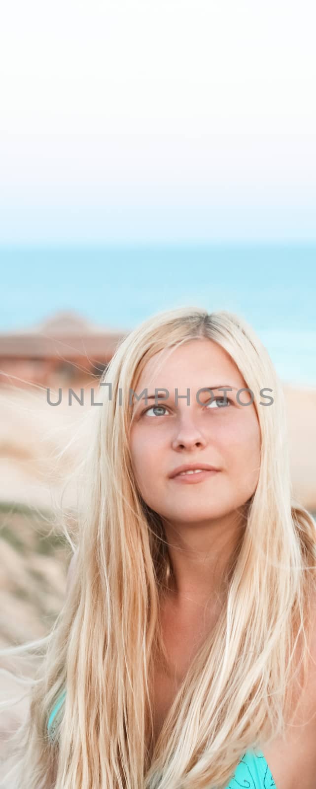 Woman with blond hair enjoying seaside and beach lifestyle in summertime, holiday travel and leisure concept