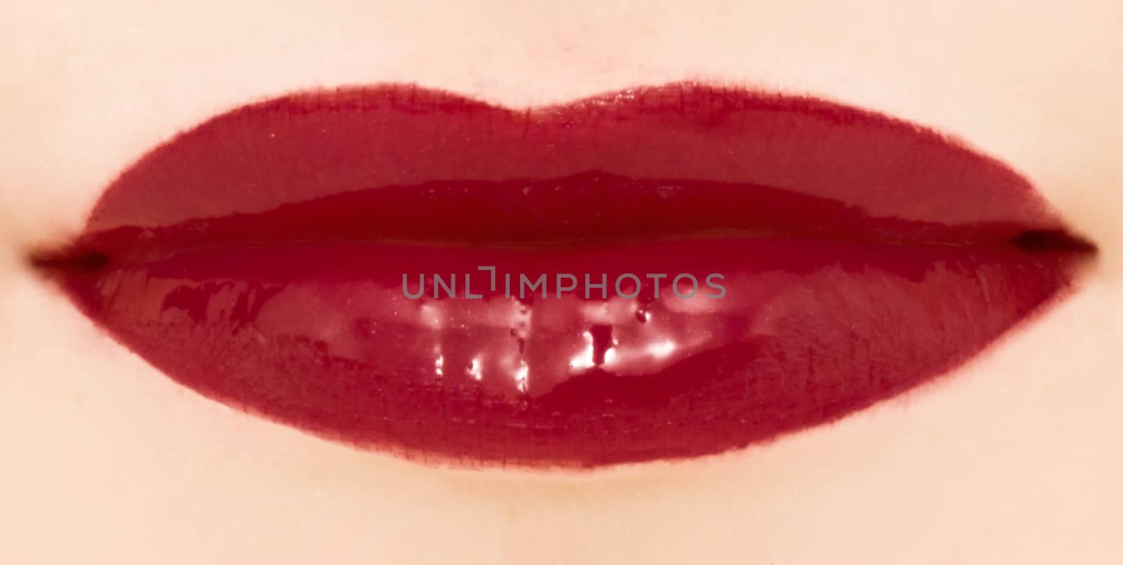 Female lips with glossy lipstick or lip gloss for make-up and beauty ads