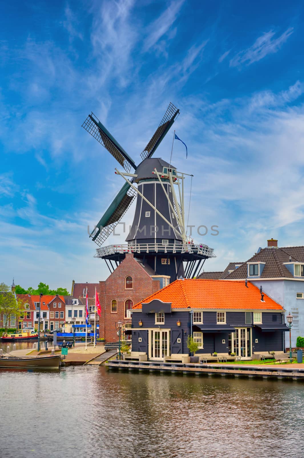 A windmill along the canals in Haarlem, Netherlands on a clear day.