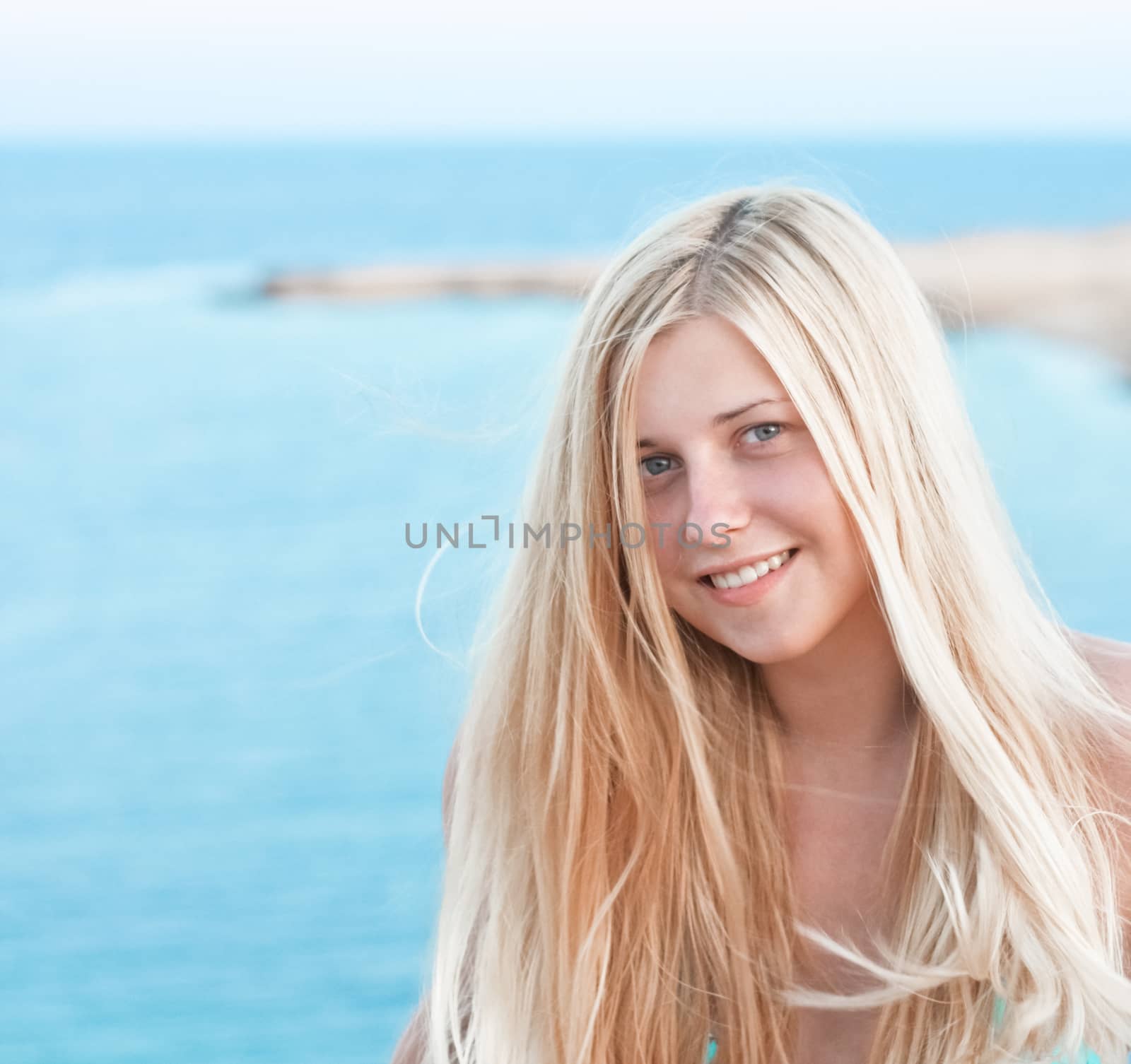 Woman with blond hair enjoying seaside and beach lifestyle in summertime, holiday travel and leisure concept