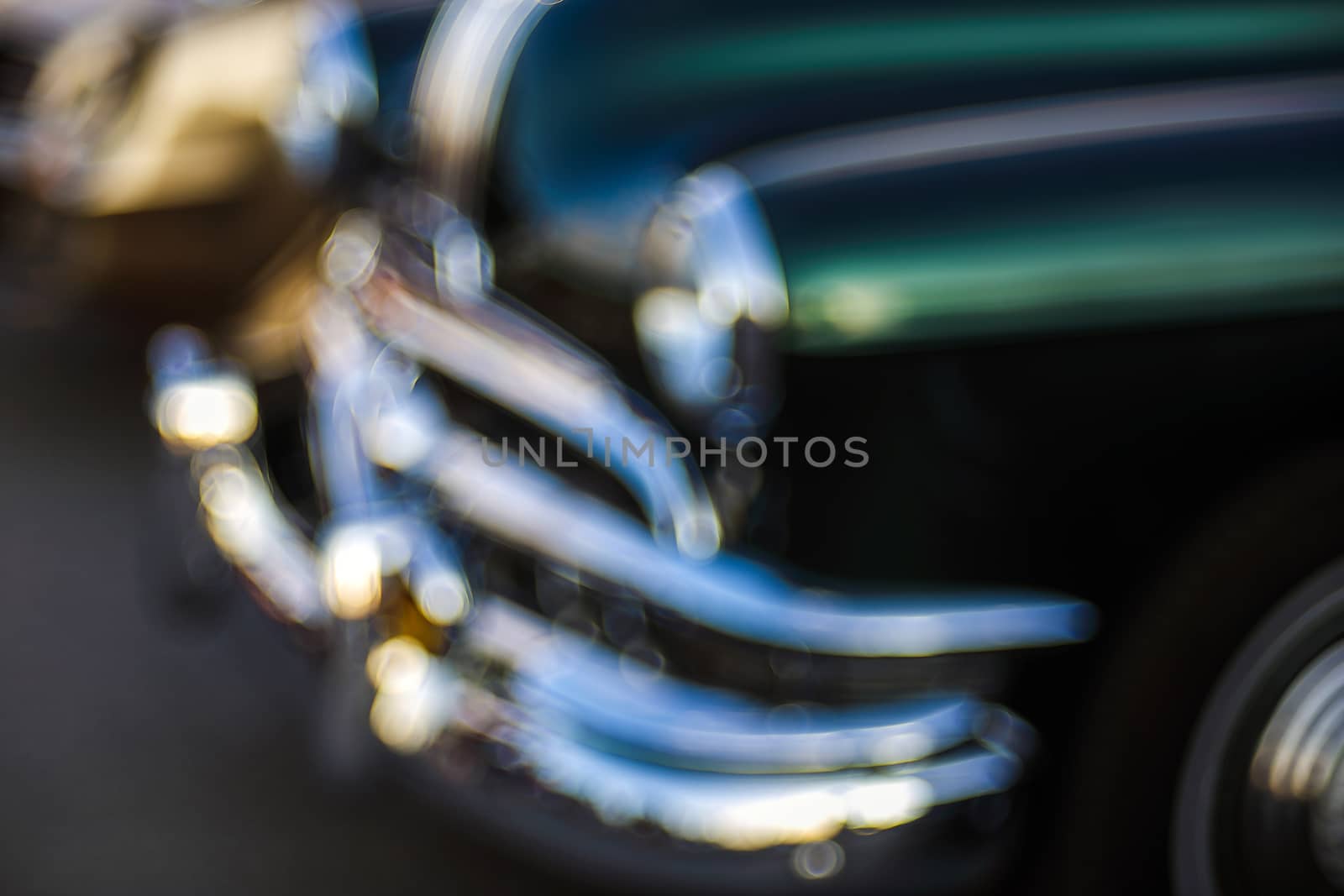 Classic car abstraction background. Soft focus, boke background with copy space. Vintage car details close up view. Abstract blur background of vintage car with bubble bokeh.