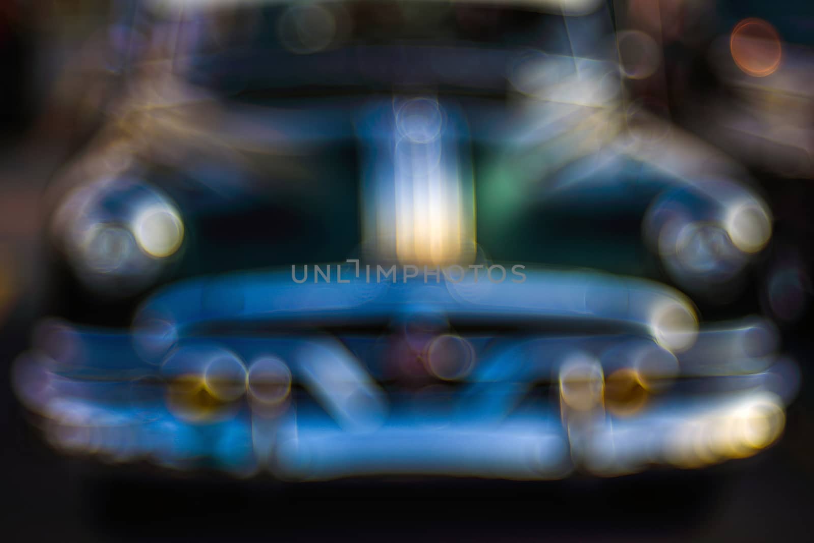 Abstract background with bokeh defocused classic car. Colorful abstract background retro car. Boke background with copy space. Close-up view vintage auto details with bubble bokeh effect.