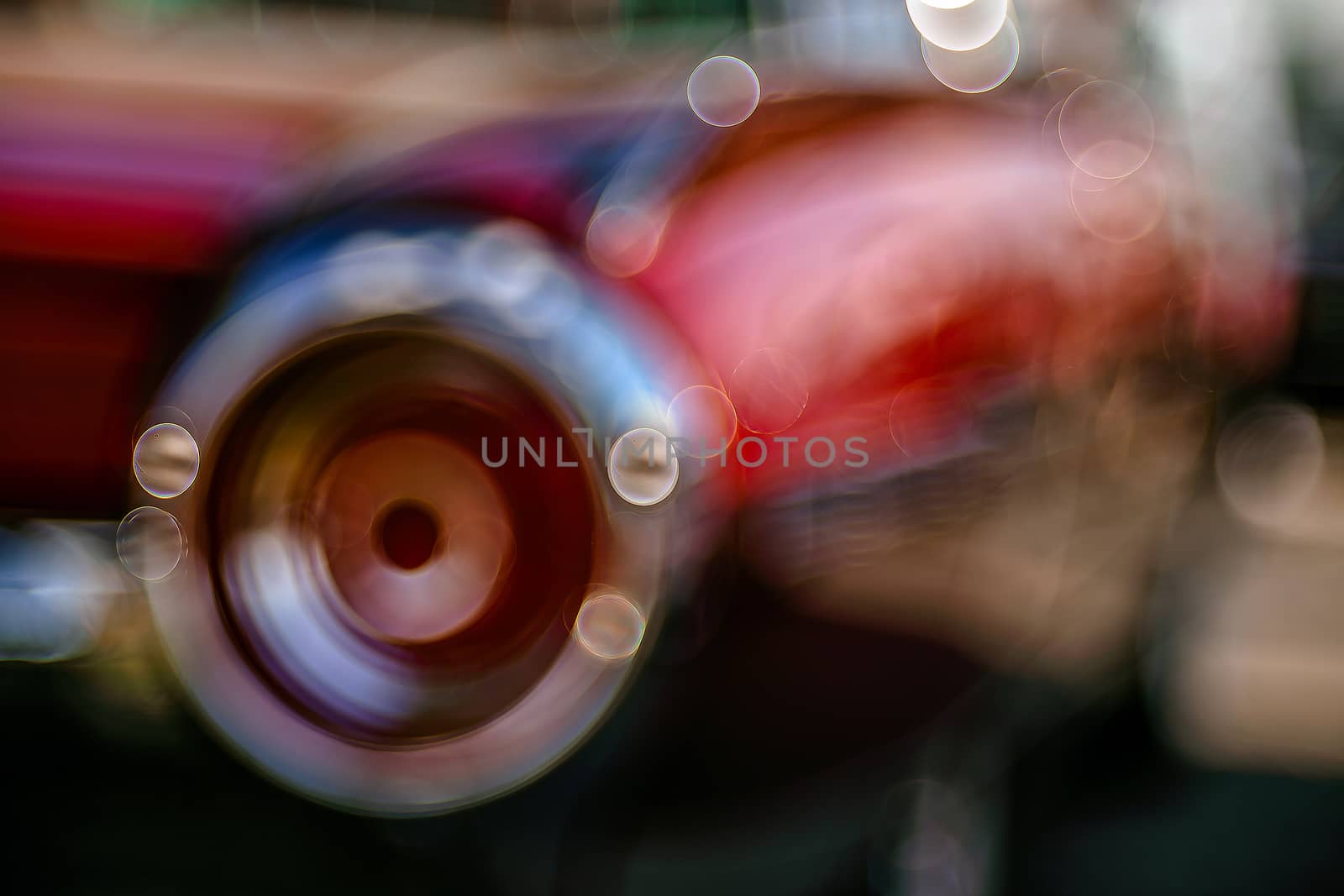 Retro rear headlight lamp vintage classic car. Soft focus, boke background with copy space. Close-up view part of a vintage old car with bubble bokeh effect.