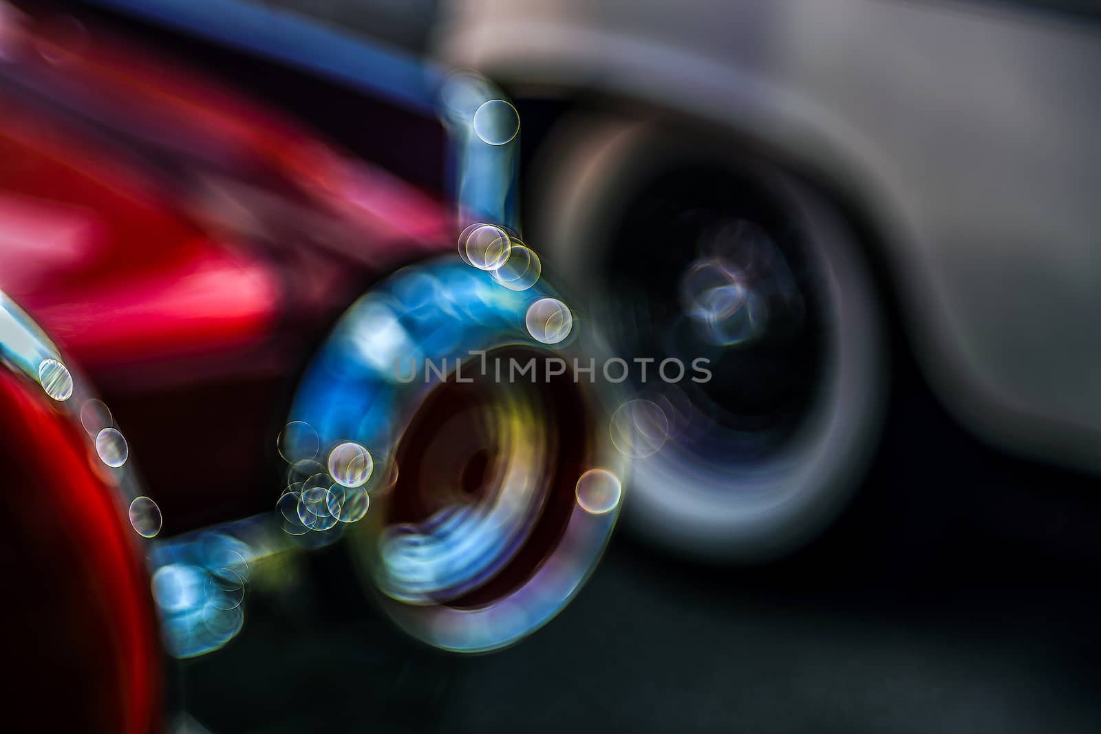 Retro rear headlight lamp vintage classic car. Soft focus, boke background with copy space. Close-up view part of a vintage old car with bubble bokeh effect.