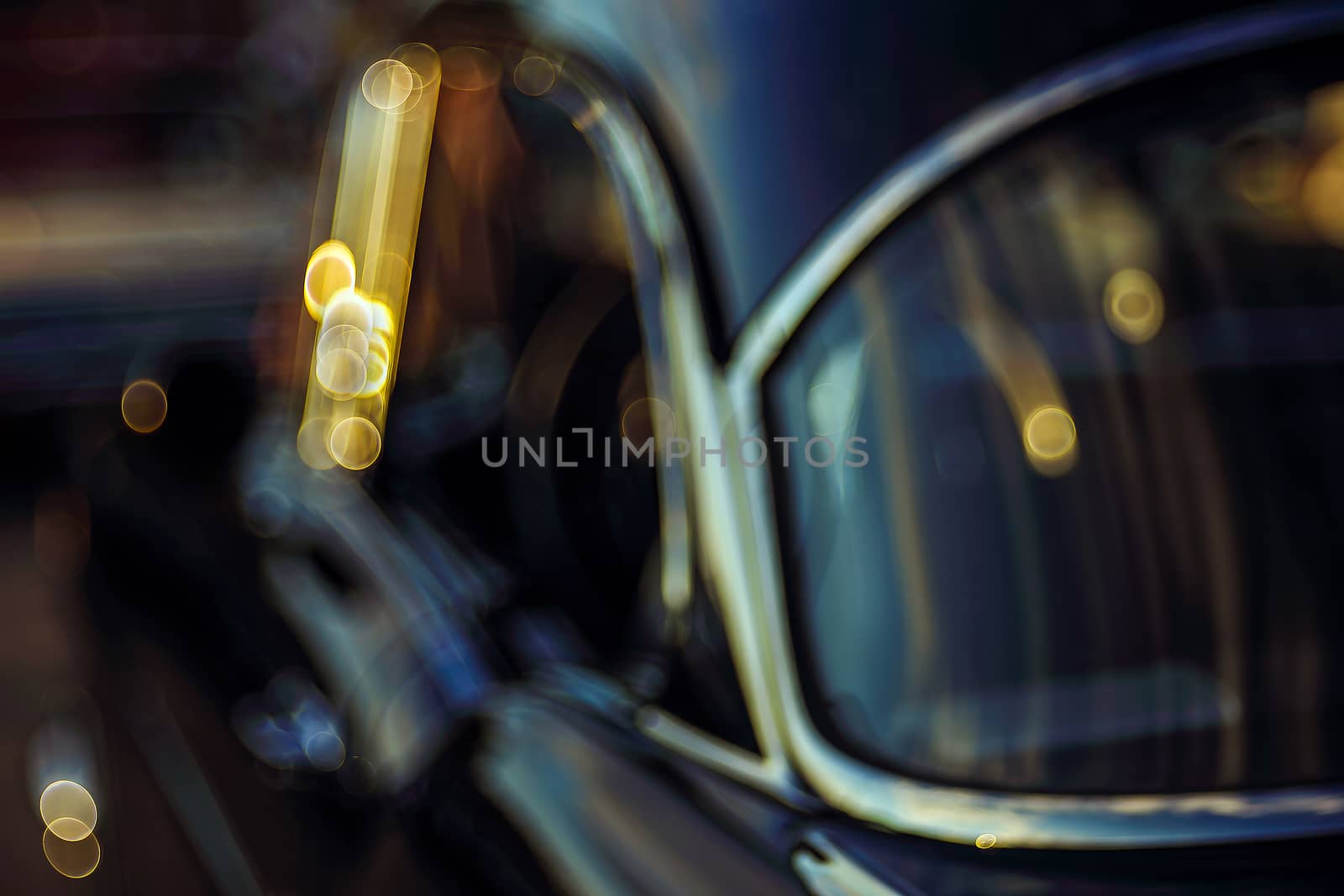 Colorful abstract background retro car. Boke background with copy space. Close-up view vintage American auto details with bubble bokeh effect. Evening.