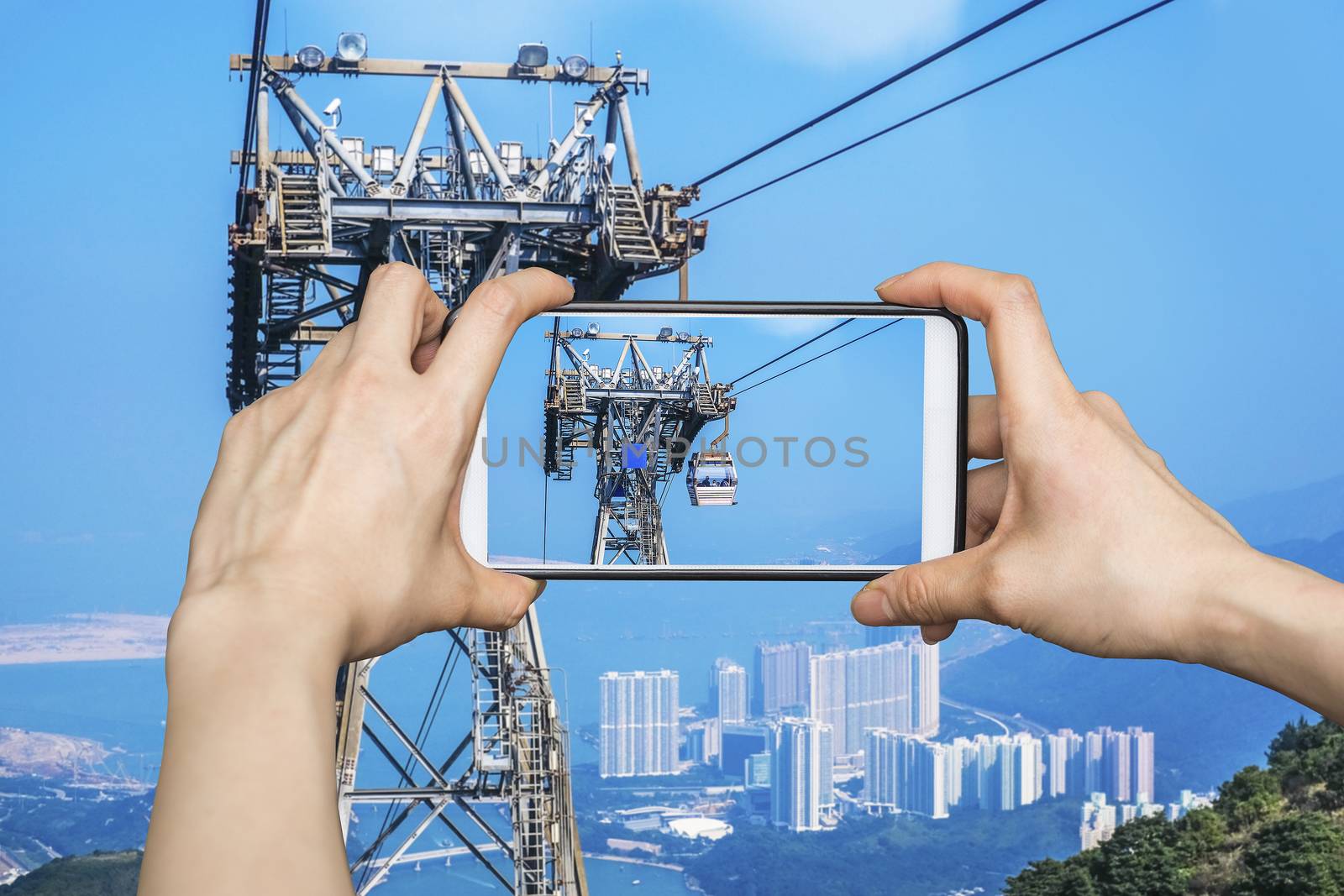 Girl taking pictures on mobile smart phone in Cable car,from Hong Kong Ocean Park