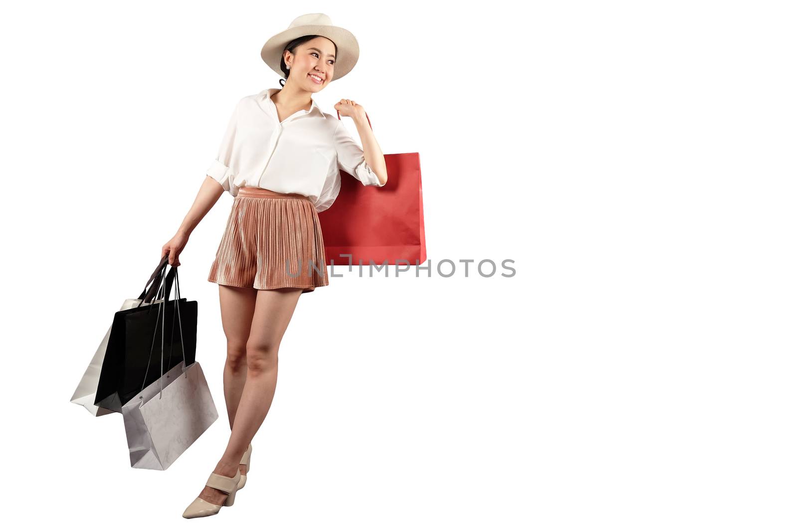 a happy women with shopping bag on white background with clippin by Surasak