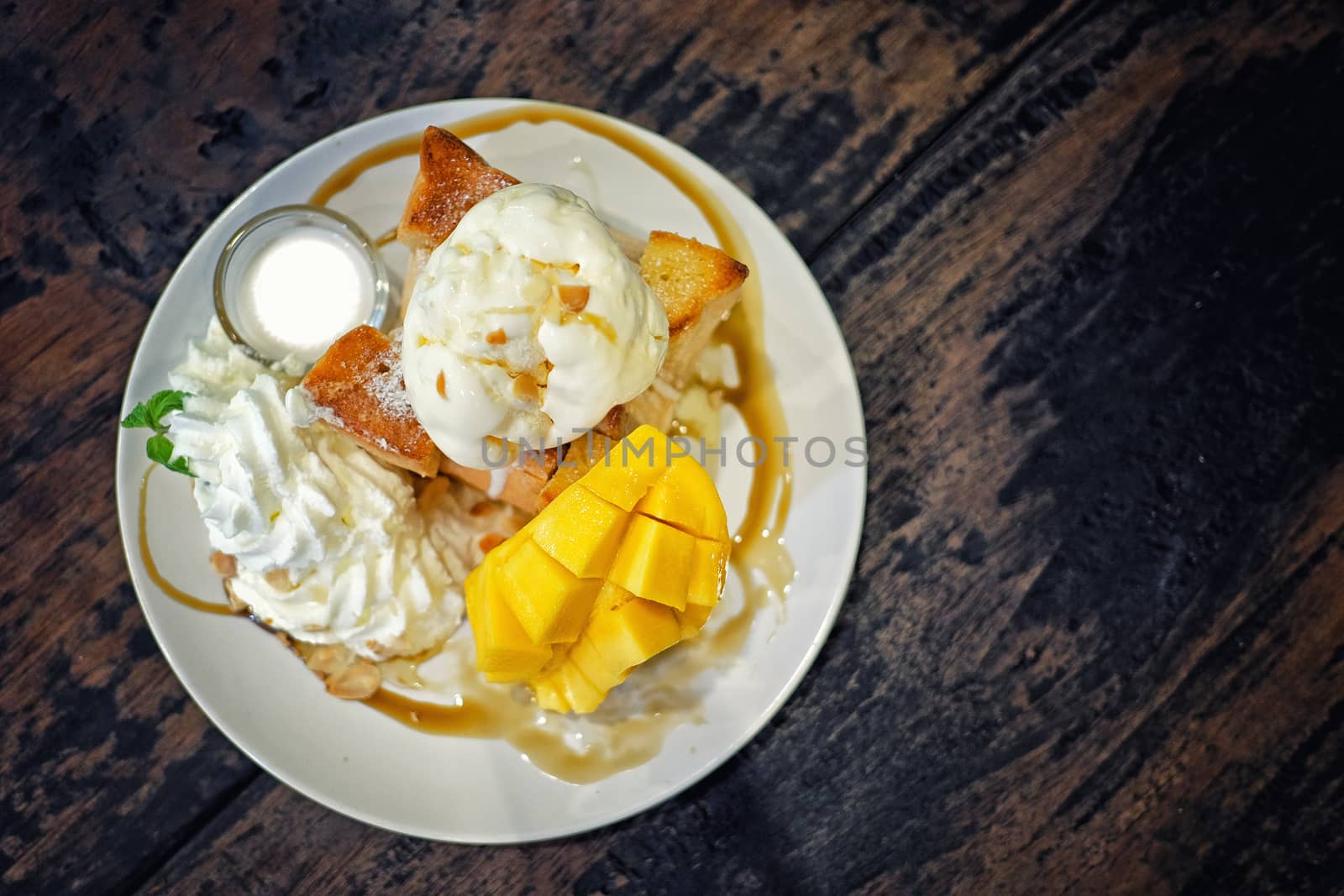 Ice cream with ripe mango and sticky rice in a coconut milk Thai style dessert.