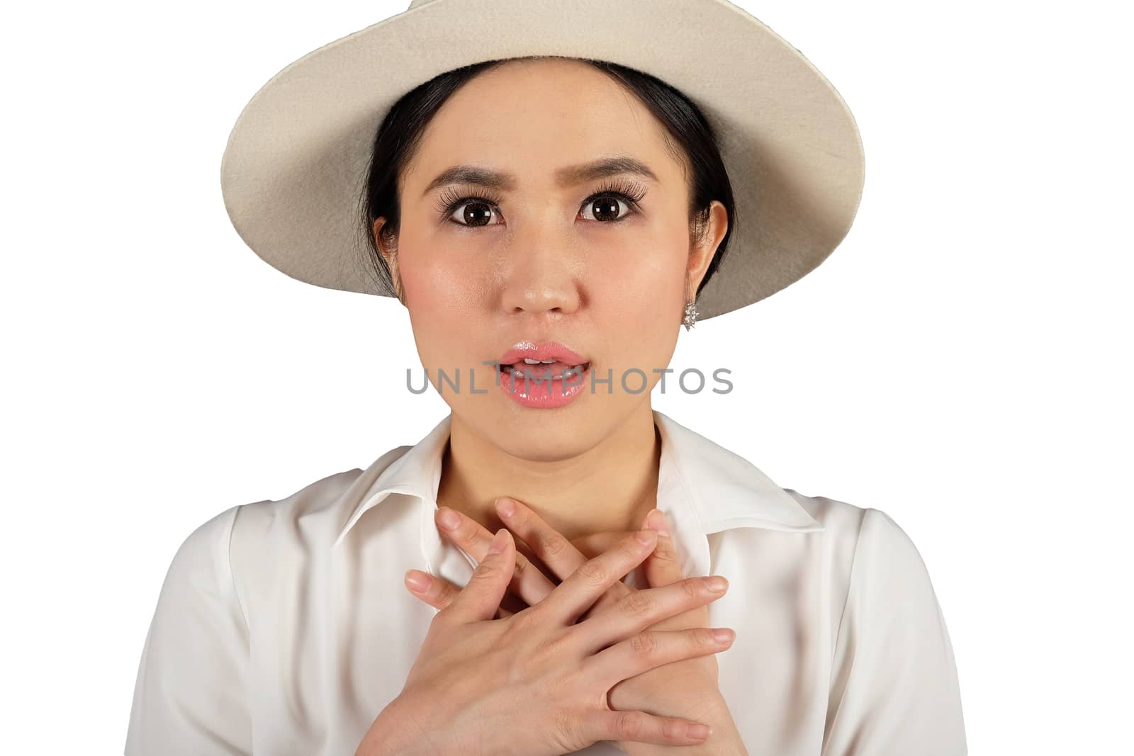 Shocked woman wearing stylish hat looking at camera and white ba by Surasak