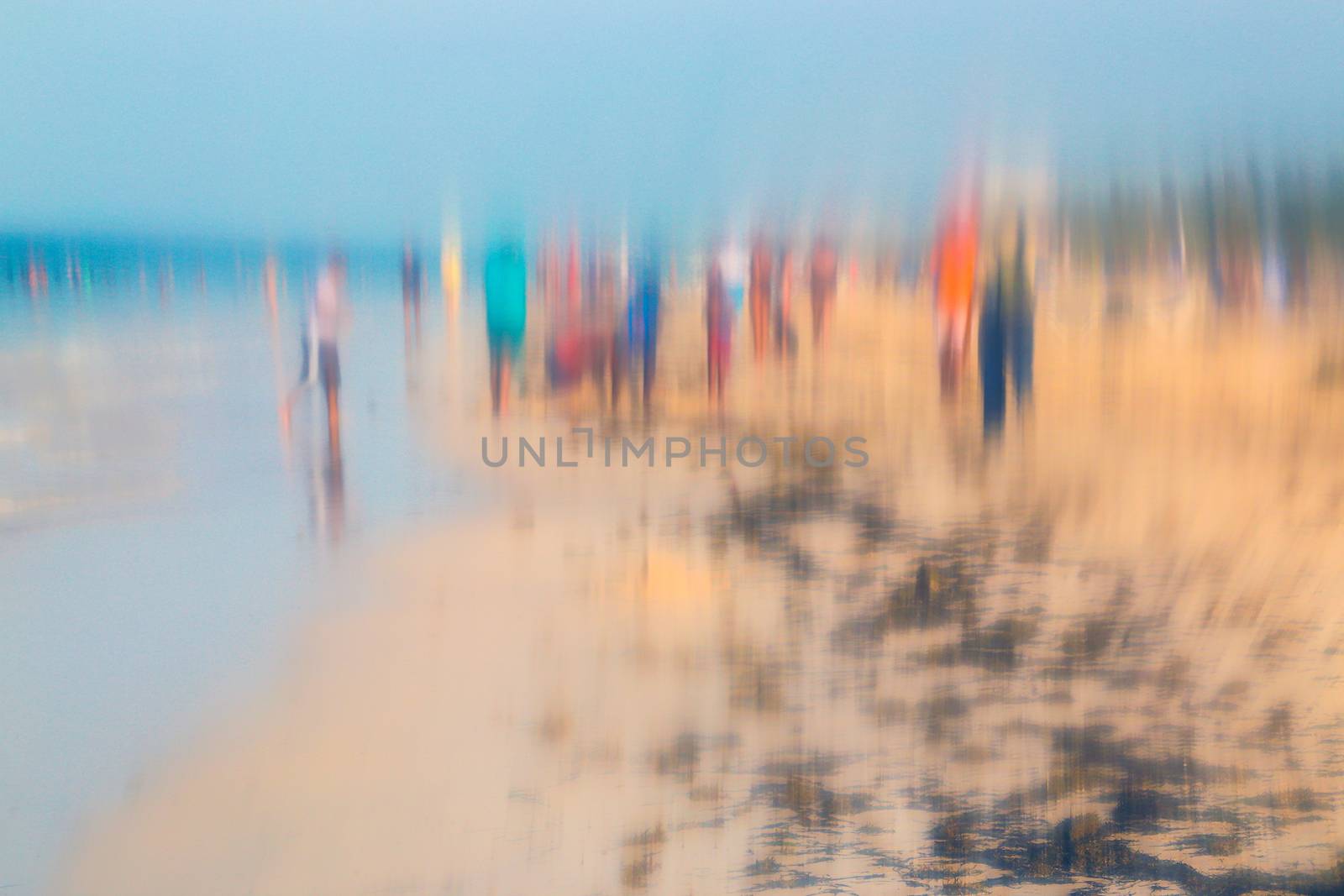 Abstract photo effect of people walking on the beach in the colorful impressionist style. Soft focus. A blurring technique creates a unique impressionist style. Pastel colours.