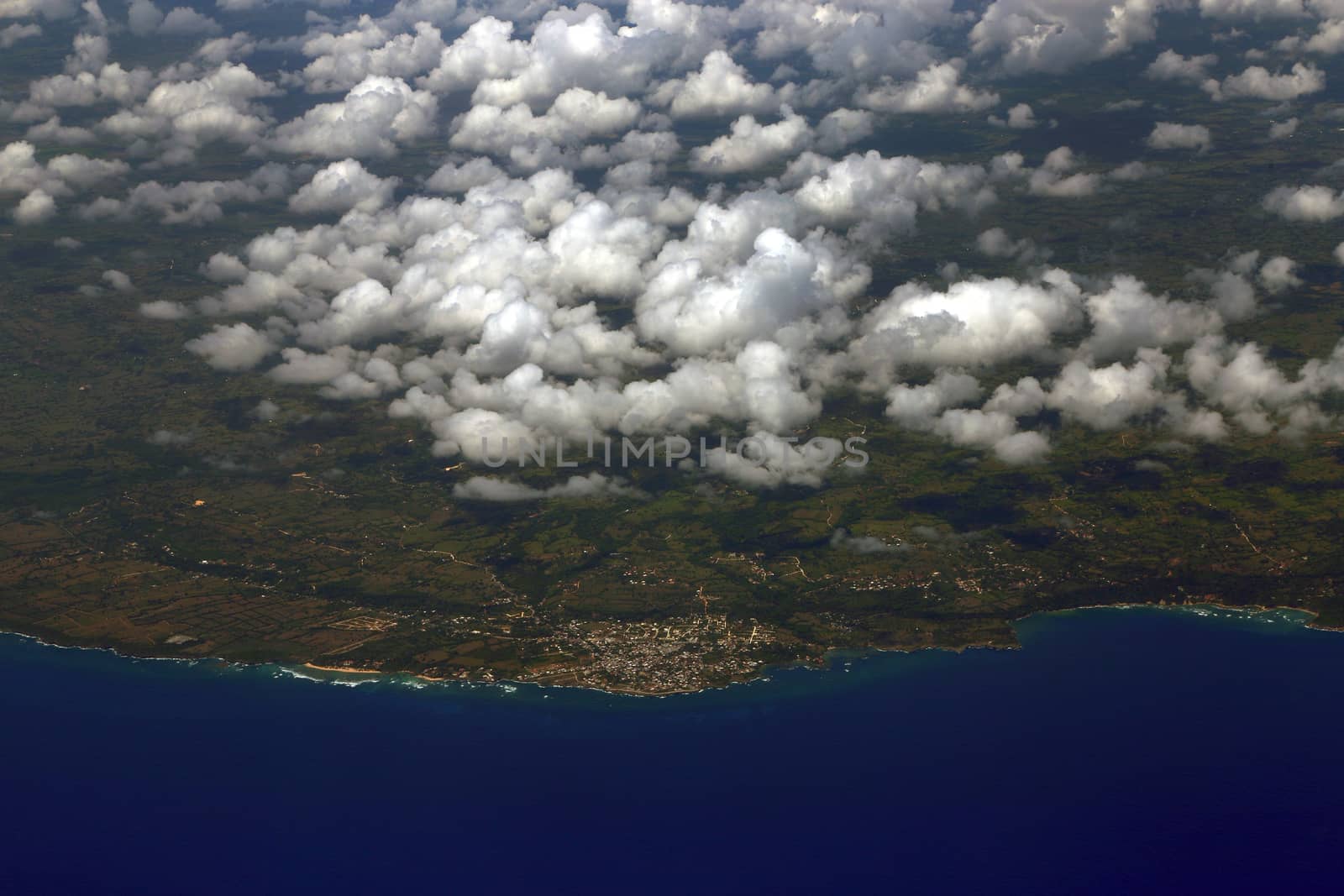 Beautiful aerial view from the plane over Punta Cana, Dominican Republic. Flying above the clouds. View from the airplane.