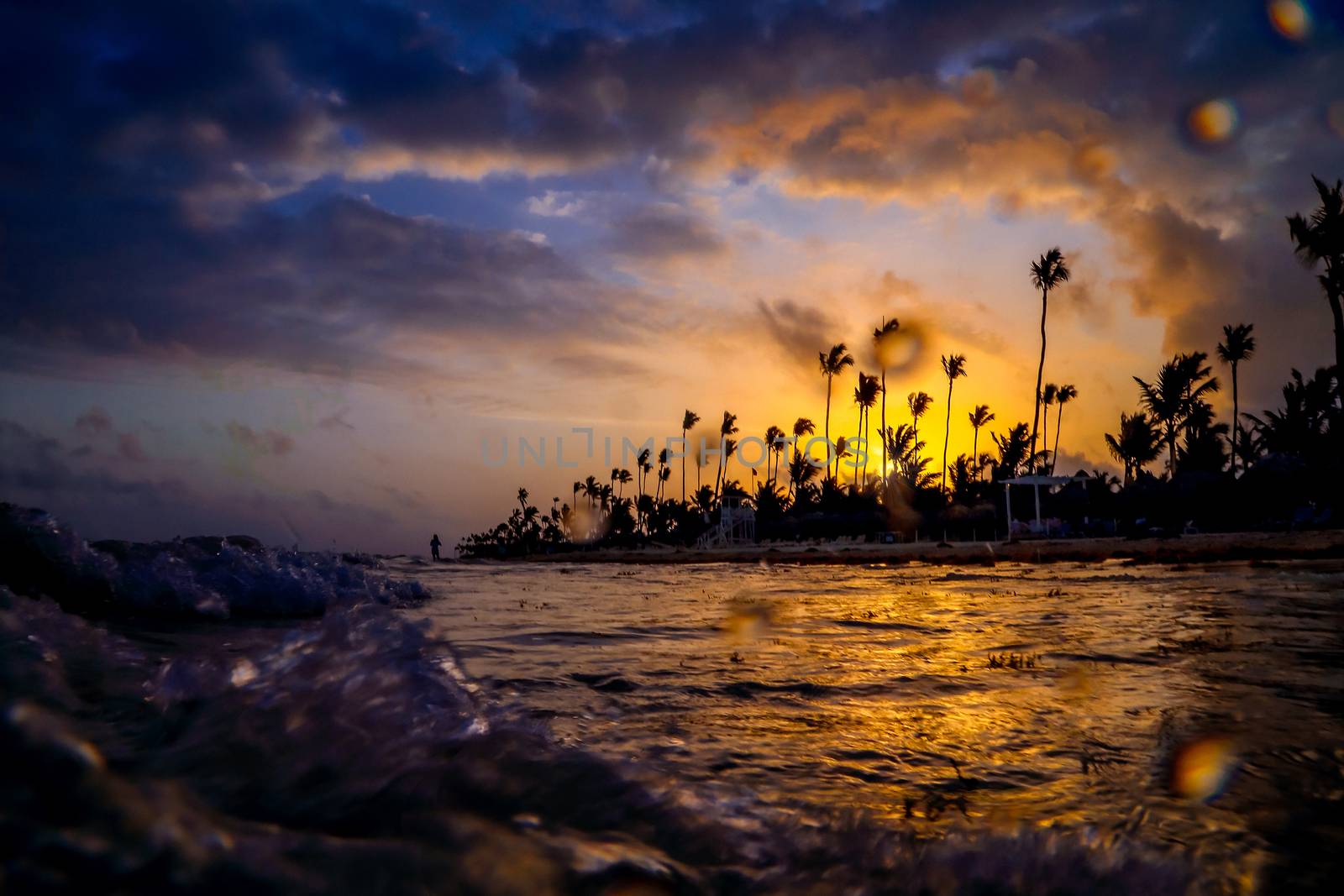 Carribean vacation, beautiful sunset over tropical beach in Punta Cana. Landscape of paradise tropical island beach, sunset shot. Incredible sunset on a tropical island in the ocean.