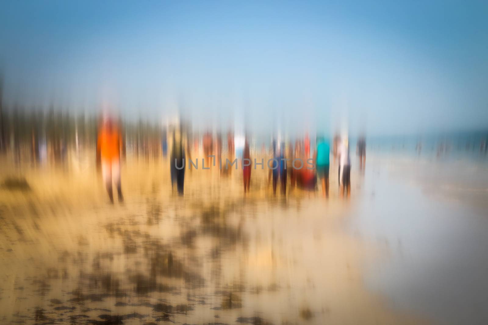 Abstract background image of people walking on the beach in the style of the Impressionists. Soft focus. A blurring technique creates a unique impressionist style. Pastel colours.