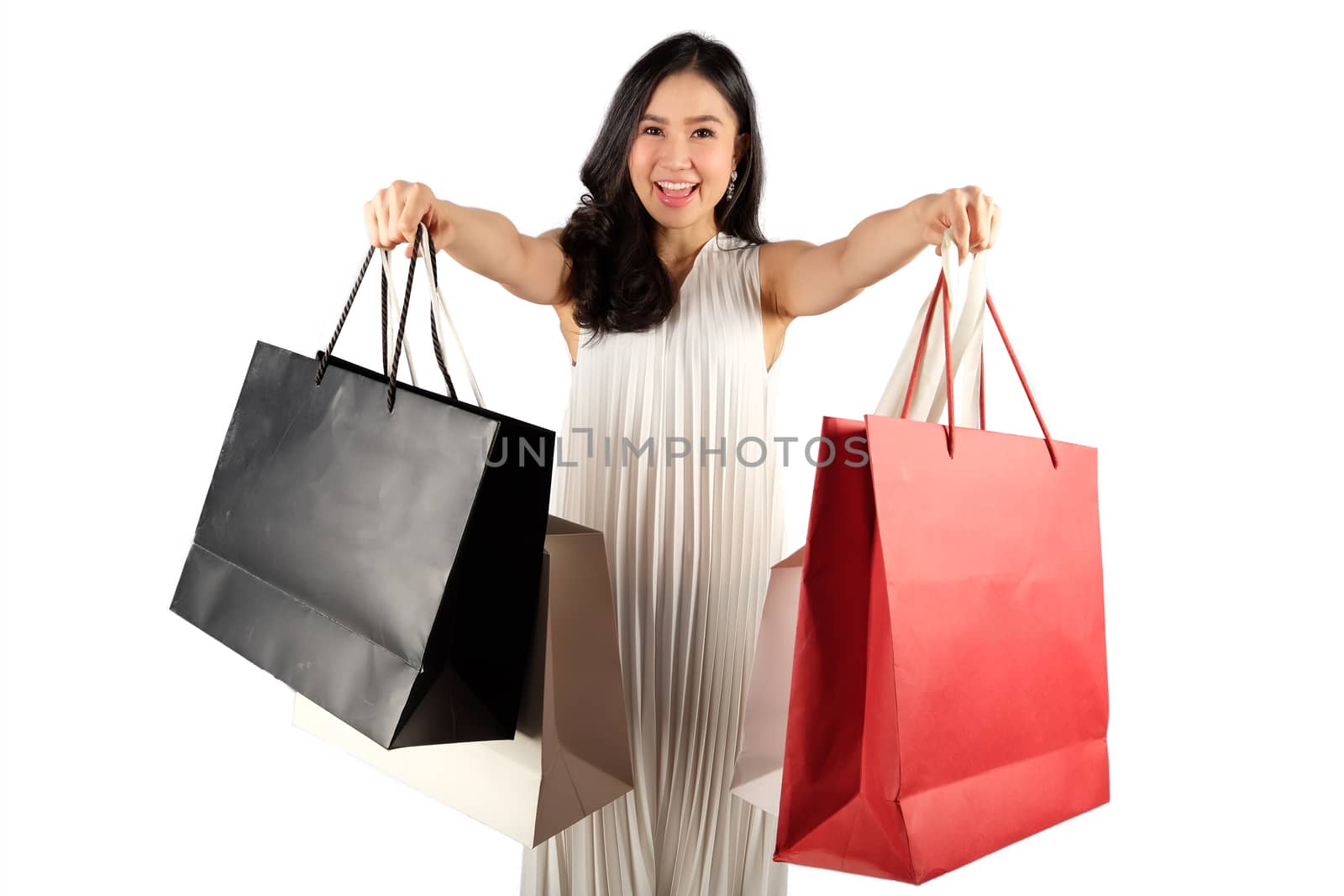 a happy women in white dress with shopping bag on white backgrou by Surasak