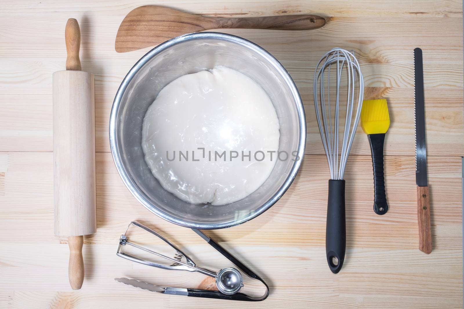 Food ingredients and kitchen utensils for cooking on wood background
