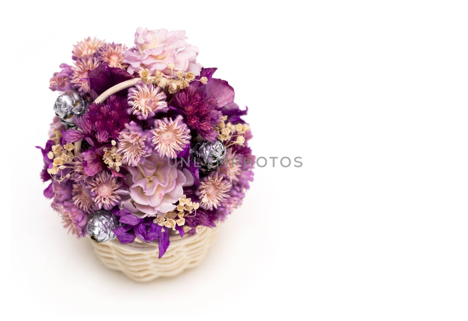 A basket of dried wild flowers on white background. Macro image.
