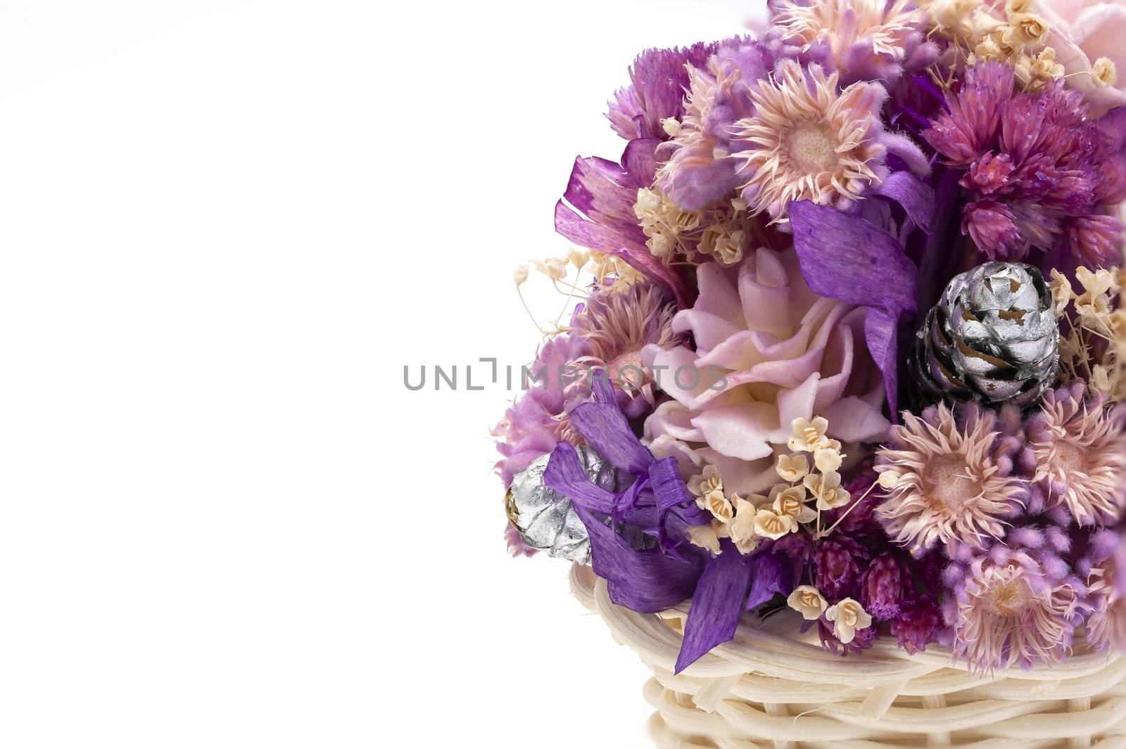 A basket of dried wild flowers on white background. Macro image. Closed up.