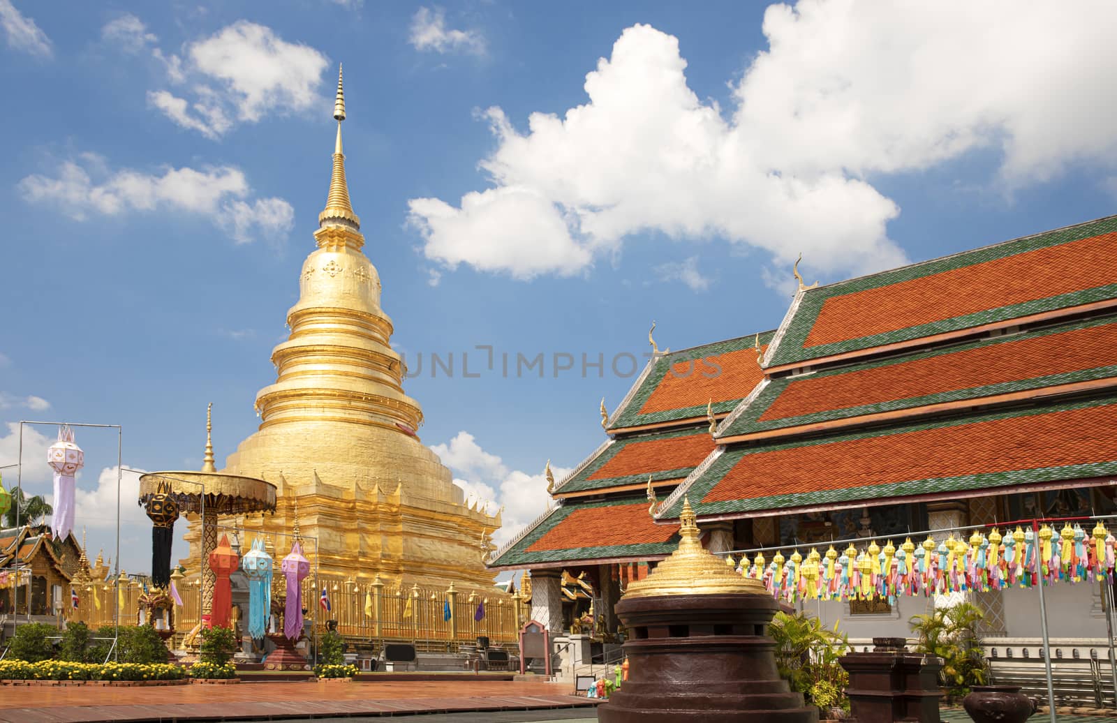 A golden pagoda at Wat Phra That Hariphunchai in Lumphun Province, Thailand after the most recent restoration in October 2019.