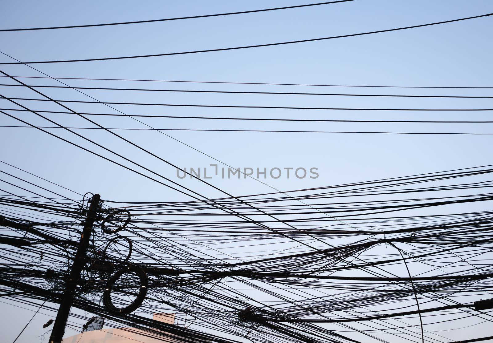 Messy electrical wires city background on clear sky