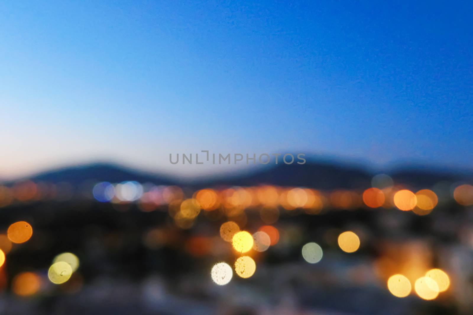 Blurred night view of a village in mountains, landscape and nature by Anneleven