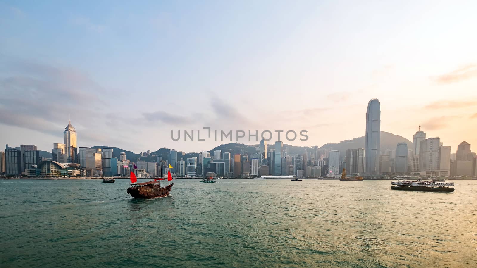 Hong Kong skyline with a traditional boat seen from Kowloon, Hong Kong, China.