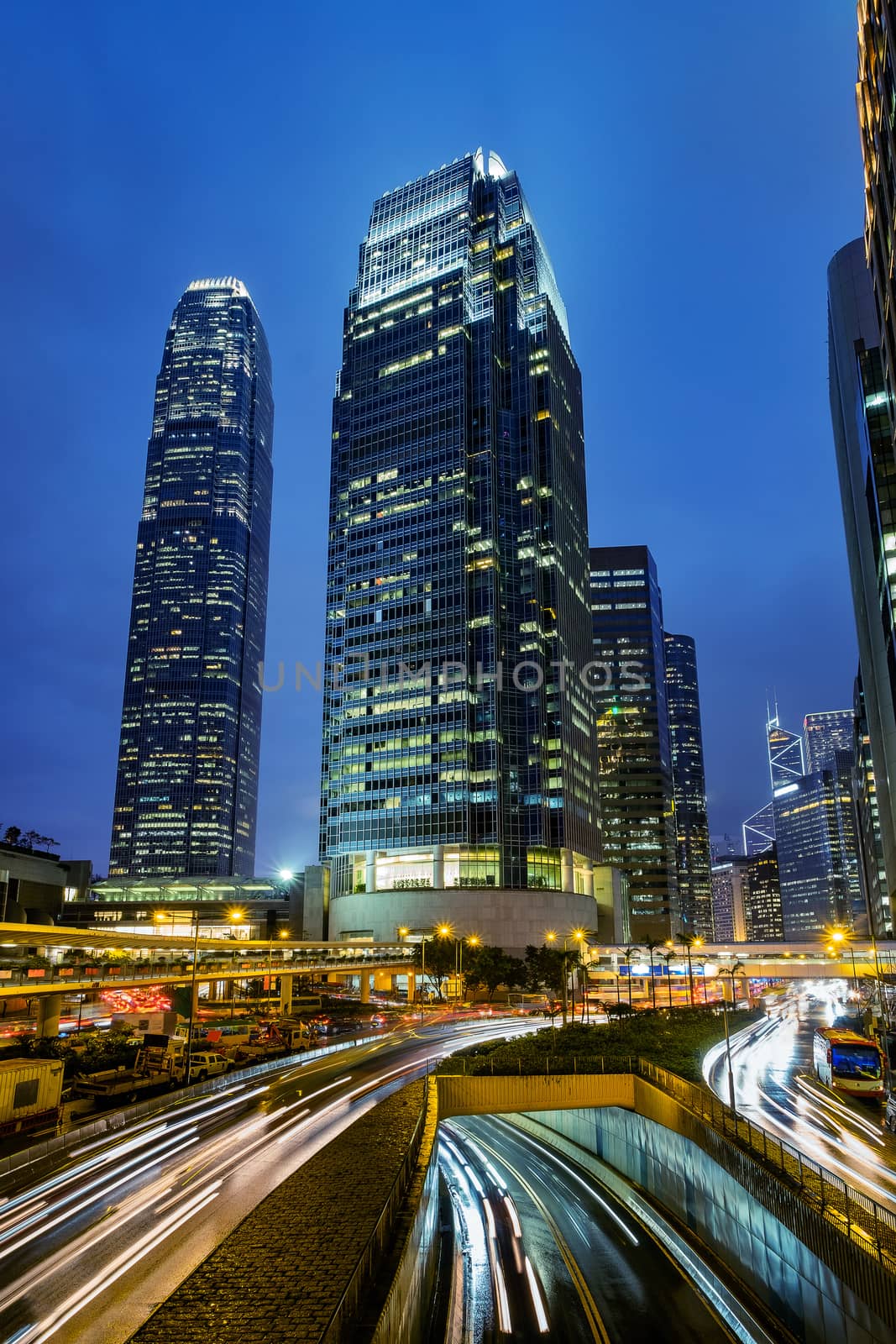 Hong Kong skyline at central business district with light trail. by Tanarch