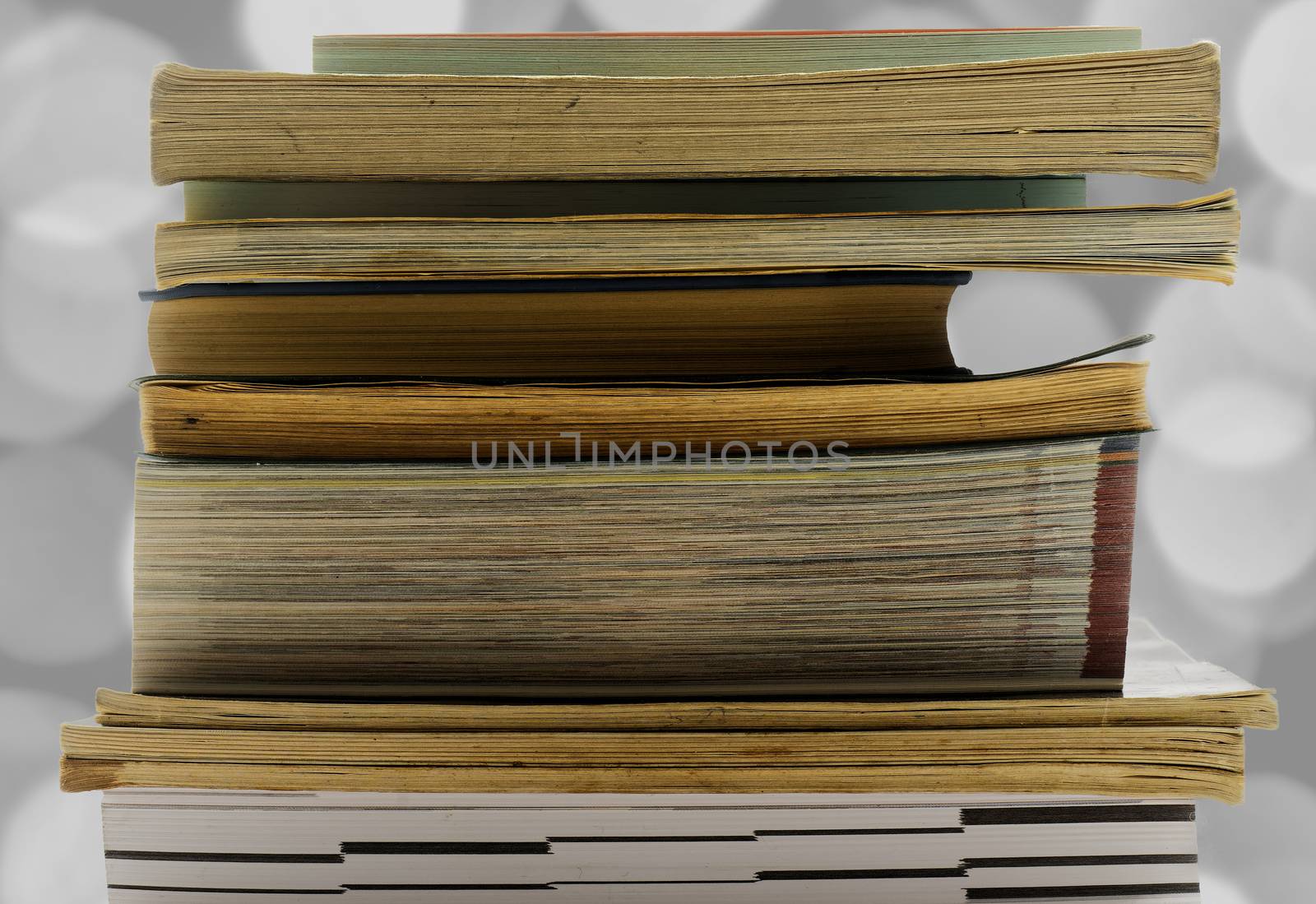 A pile of old and used books released and isolated against a white background, for reading