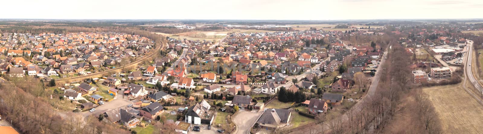 Composite panorama of aerial photographs and aerial photos of a small village in the heath in Northern Germany with meadows, fields and houses, above the roofs, made with drone