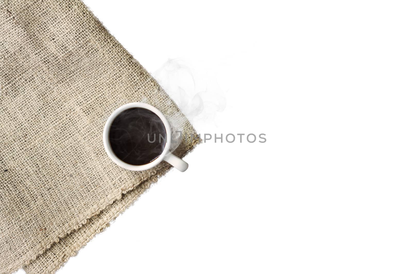 A cup of black coffee with smoke on sackcloth napkin, isolated on white background. by asiandelight