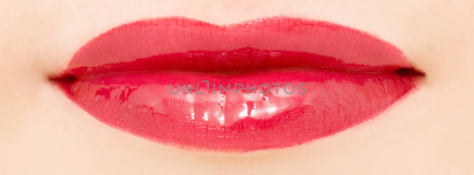 Female lips with glossy lipstick or lip gloss for make-up and beauty by Anneleven