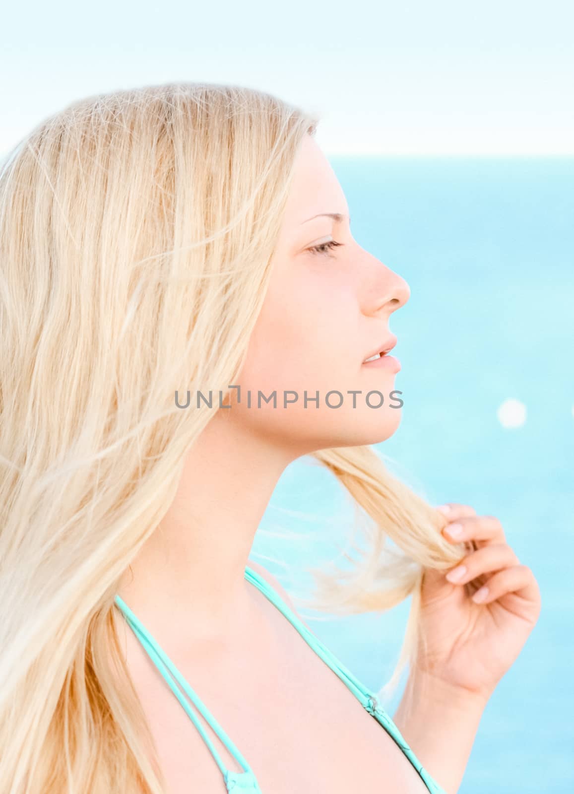 Woman with blond hair enjoying seaside and beach lifestyle in summertime, holiday travel and leisure by Anneleven