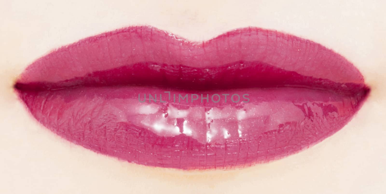 Female lips with glossy lipstick or lip gloss for make-up and beauty by Anneleven