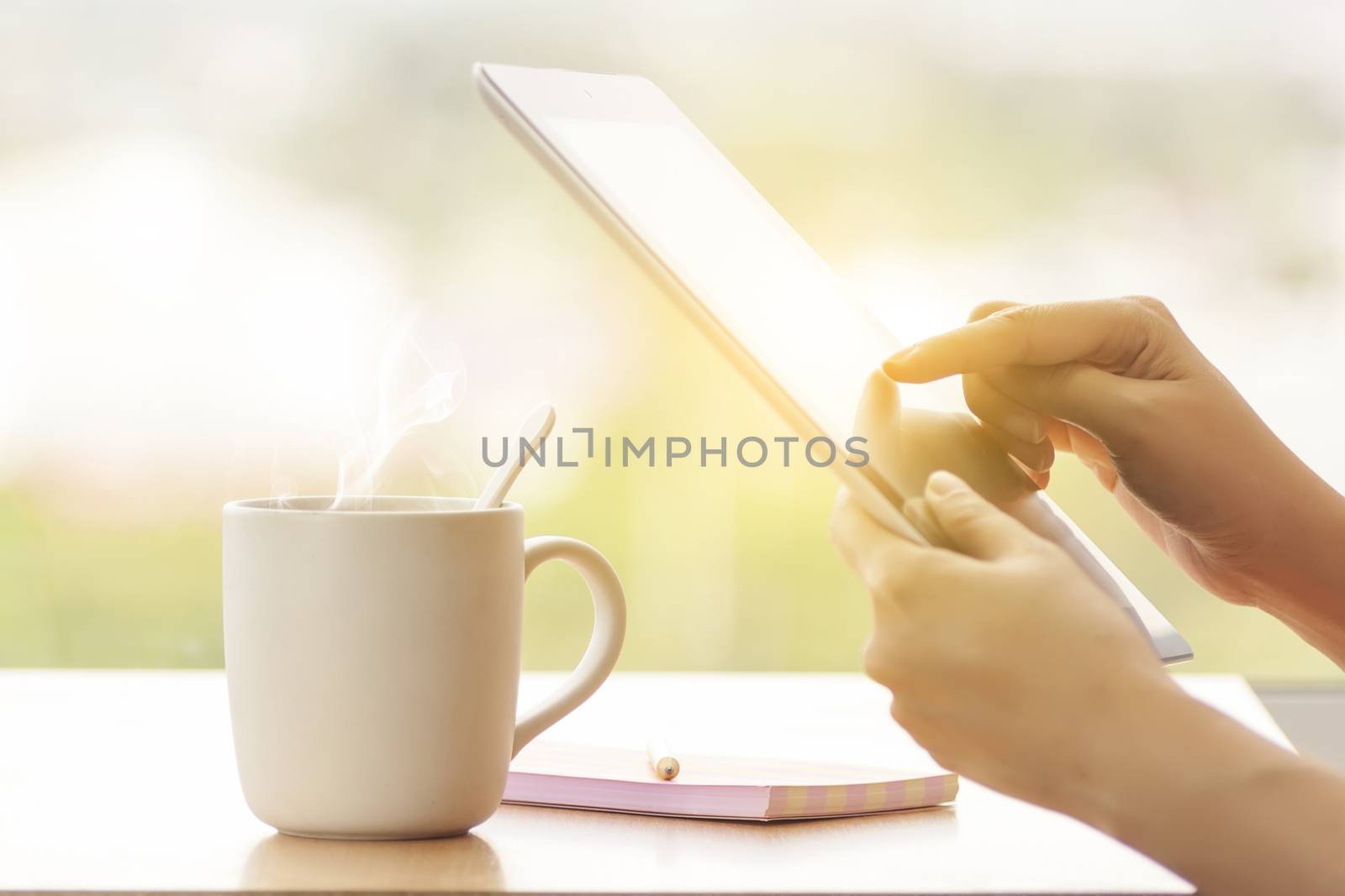 close up hands multitasking woman using tablet, laptop and cellphone connecting wifi, anonymous face by asiandelight