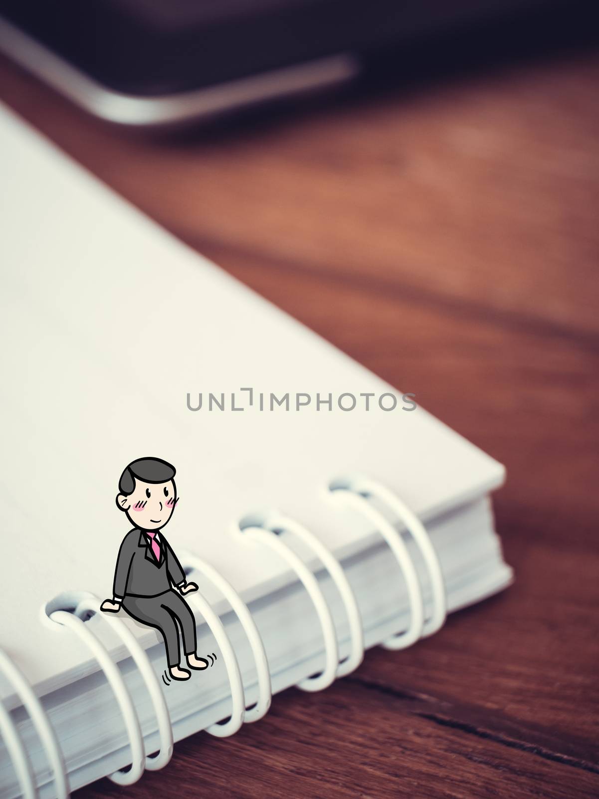 Happy businessman concept : Tiny cartoon man sit on note book in suit having break with smiley face by asiandelight