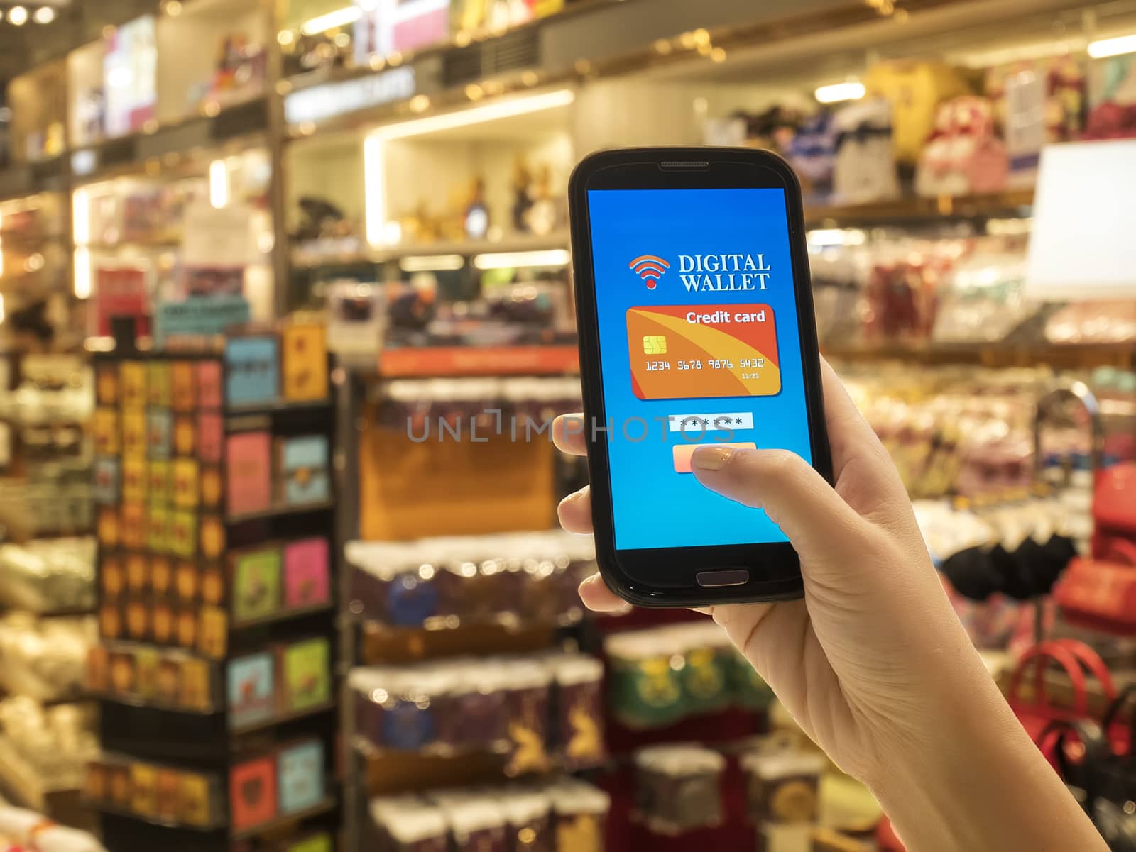 Mobile wallet concept on smart phone screen over blur store background, e-commerce, smart pay, business and technology concept by asiandelight