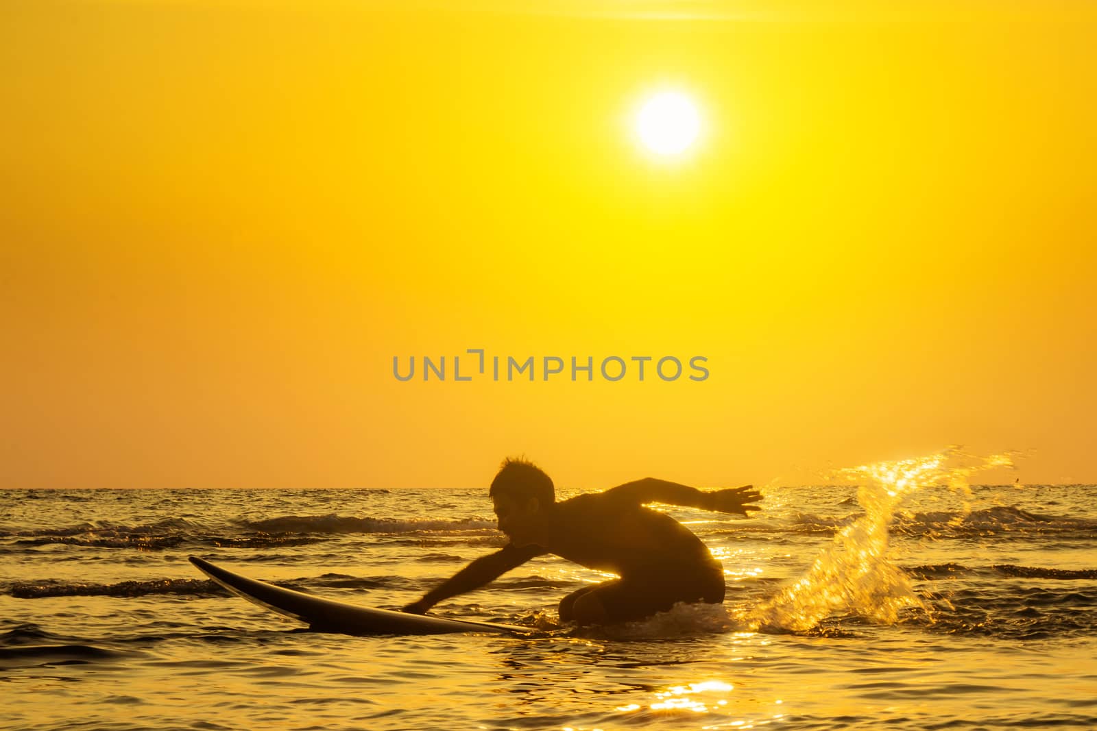 Surfing at Sunset. Outdoor Active Lifestyle. Summer water sport. by asiandelight