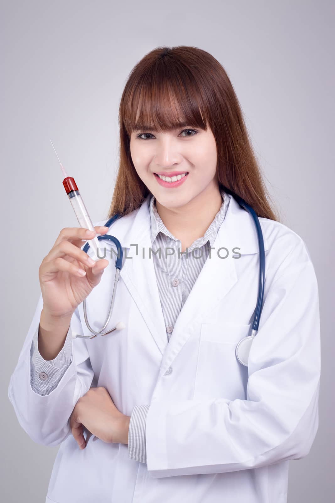 Healthy concept : Young Asian doctor with hypodermic syringe in hand
