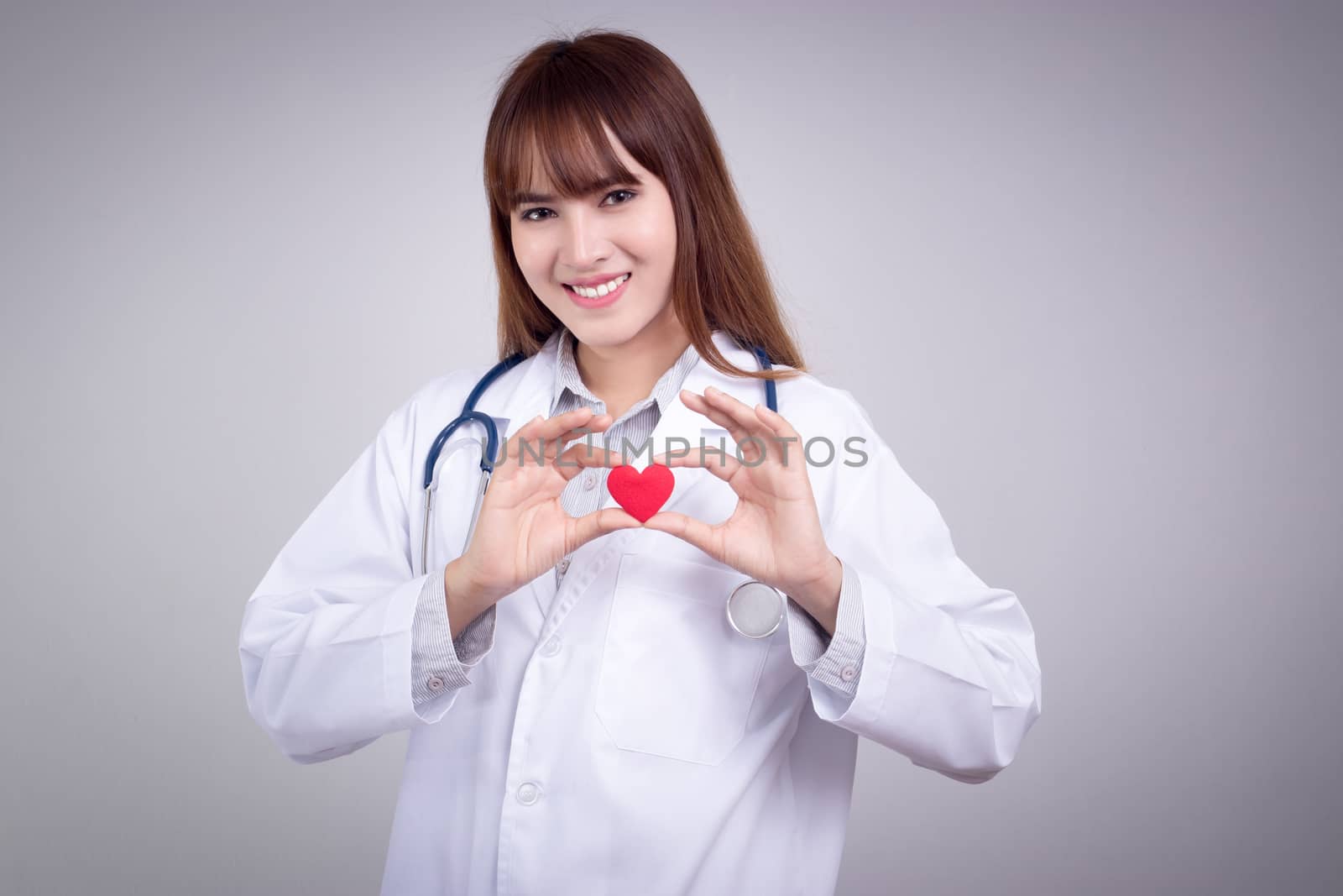 Healthy concept : Young Asian doctor with red heart in hand