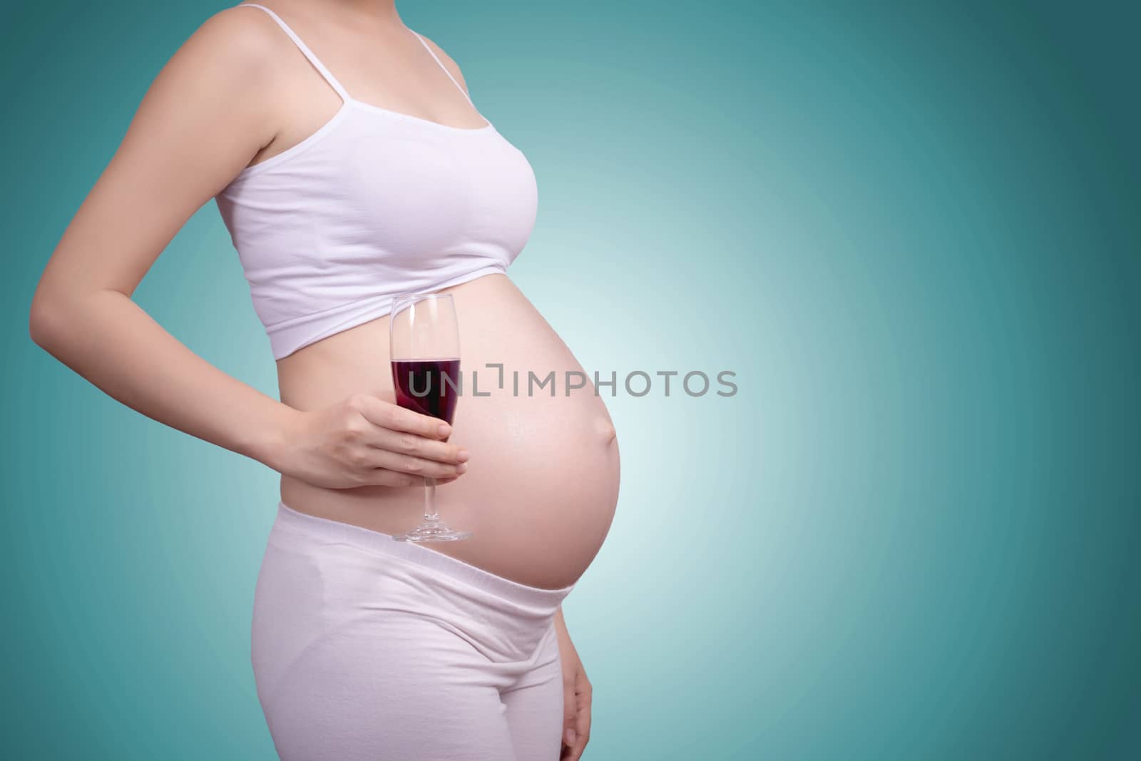 Pregnant healthy concept. A portrait of a Beautiful asian pregnant woman with glass of wine in hand.Clipping path include
