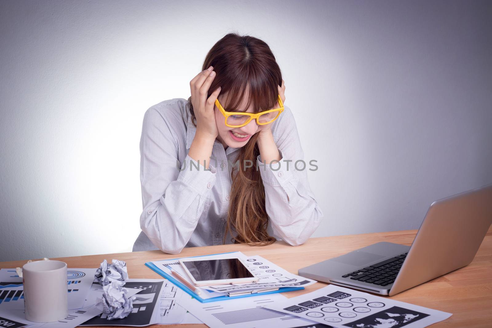 Feeling tired and stress. A stressed Asian business woman looks tired in her office