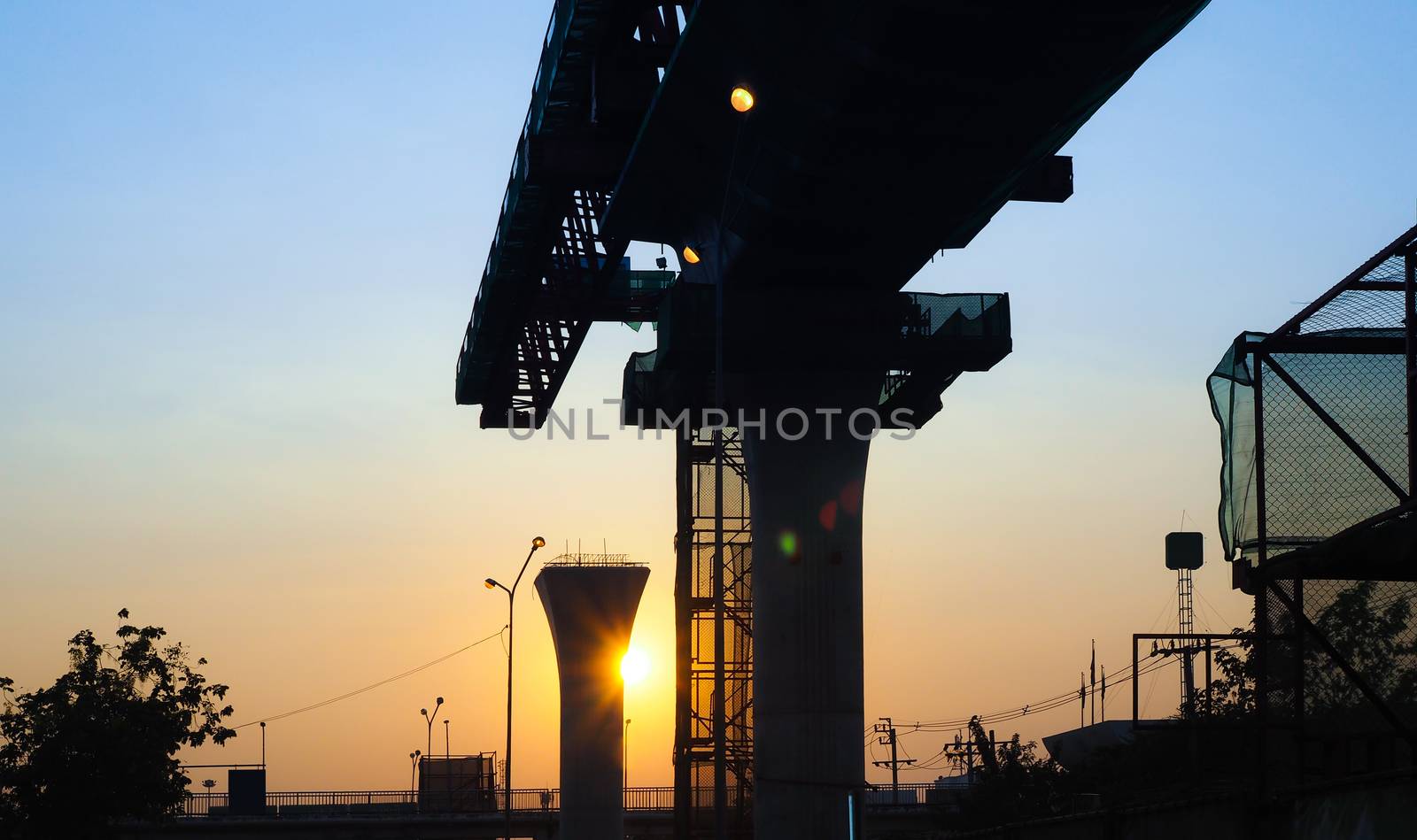 Sunset on the Poles and structures that are under construction. by kittima05