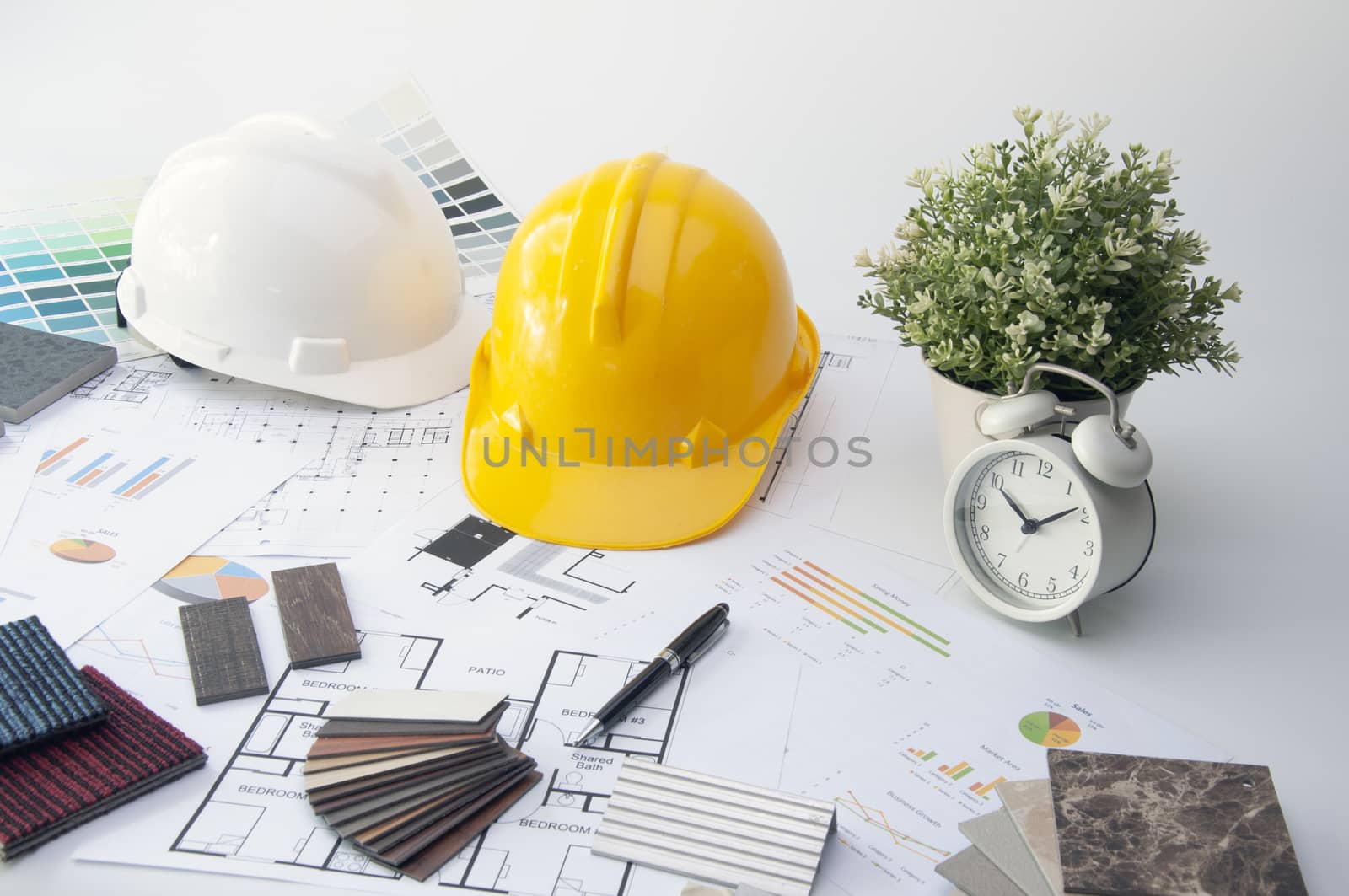 Sample of Mable stone. Materials Construction. House planning on the Interior Desk. Safety Helmet on the desk of Interior Design.